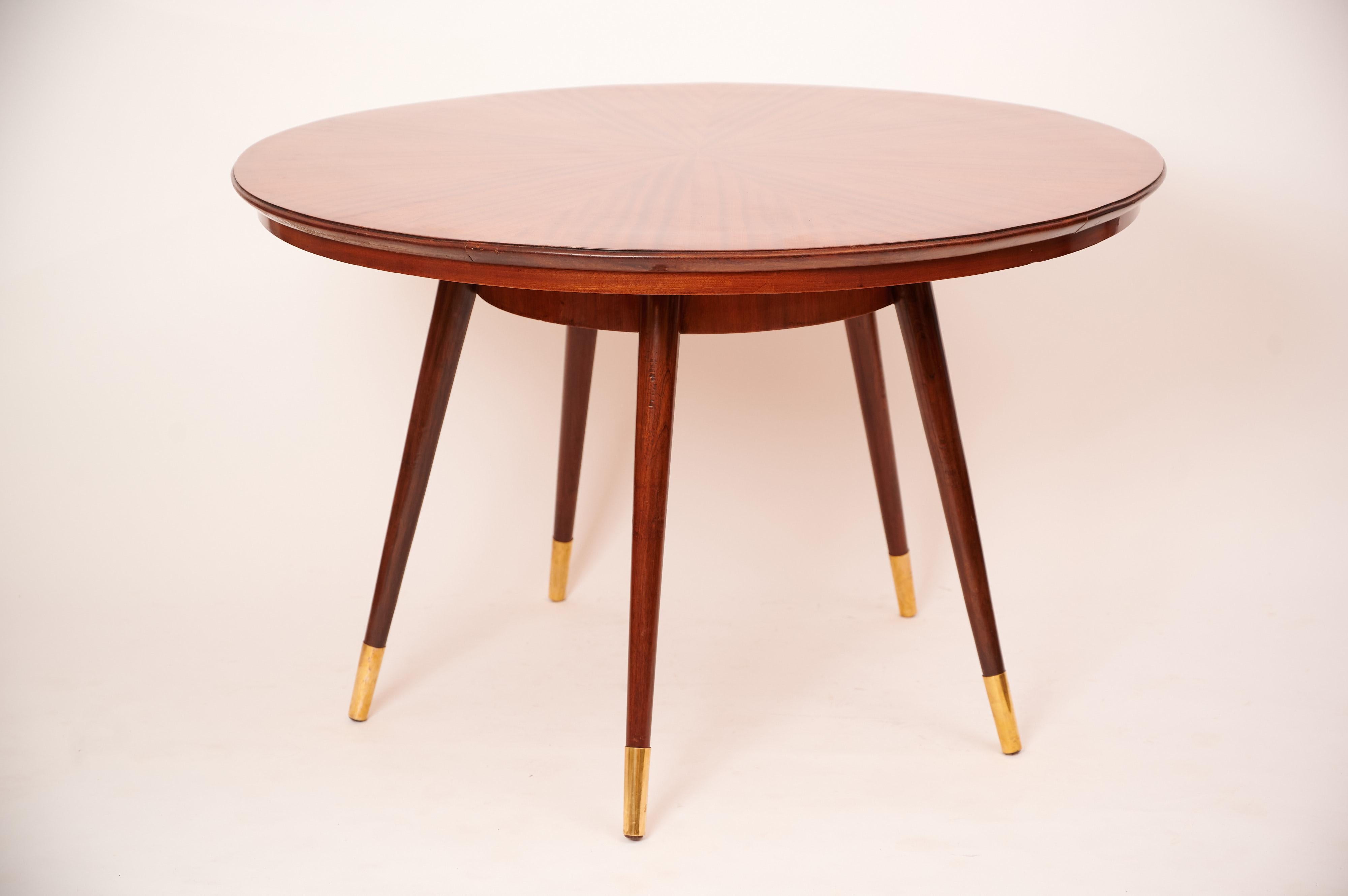 Elegantly designed circular centre table in the style of Gio Ponti c1950

Exotic wood marquetry on the table top with brass sabots on each leg.

Sympathetically restored.

 