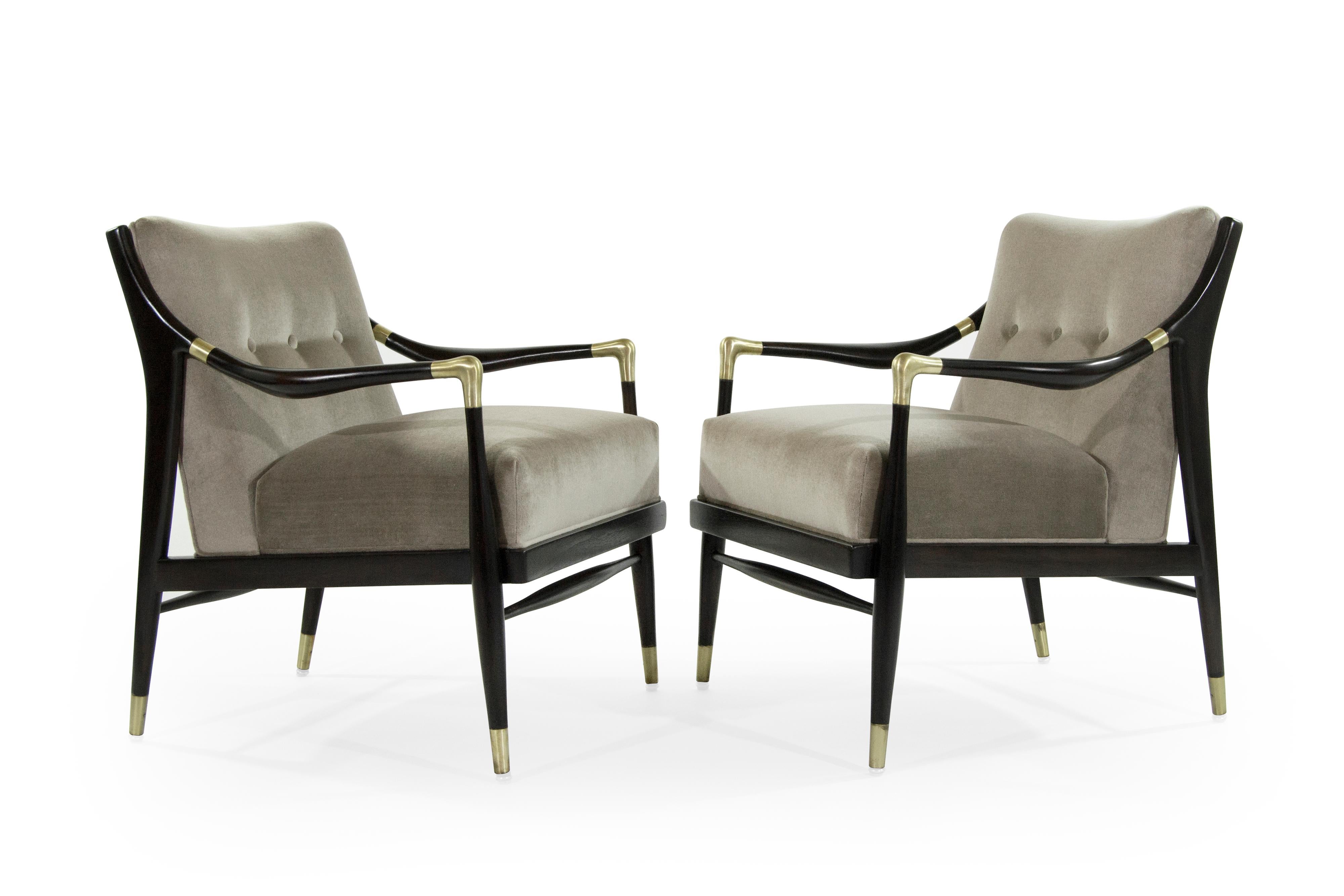 A gorgeous pair of sculptural lounge chairs with brass accents on arms and sabots in the style of Gio Ponti.

Walnut fully restored and stained in espresso. Newly upholstered in taupe mohair.