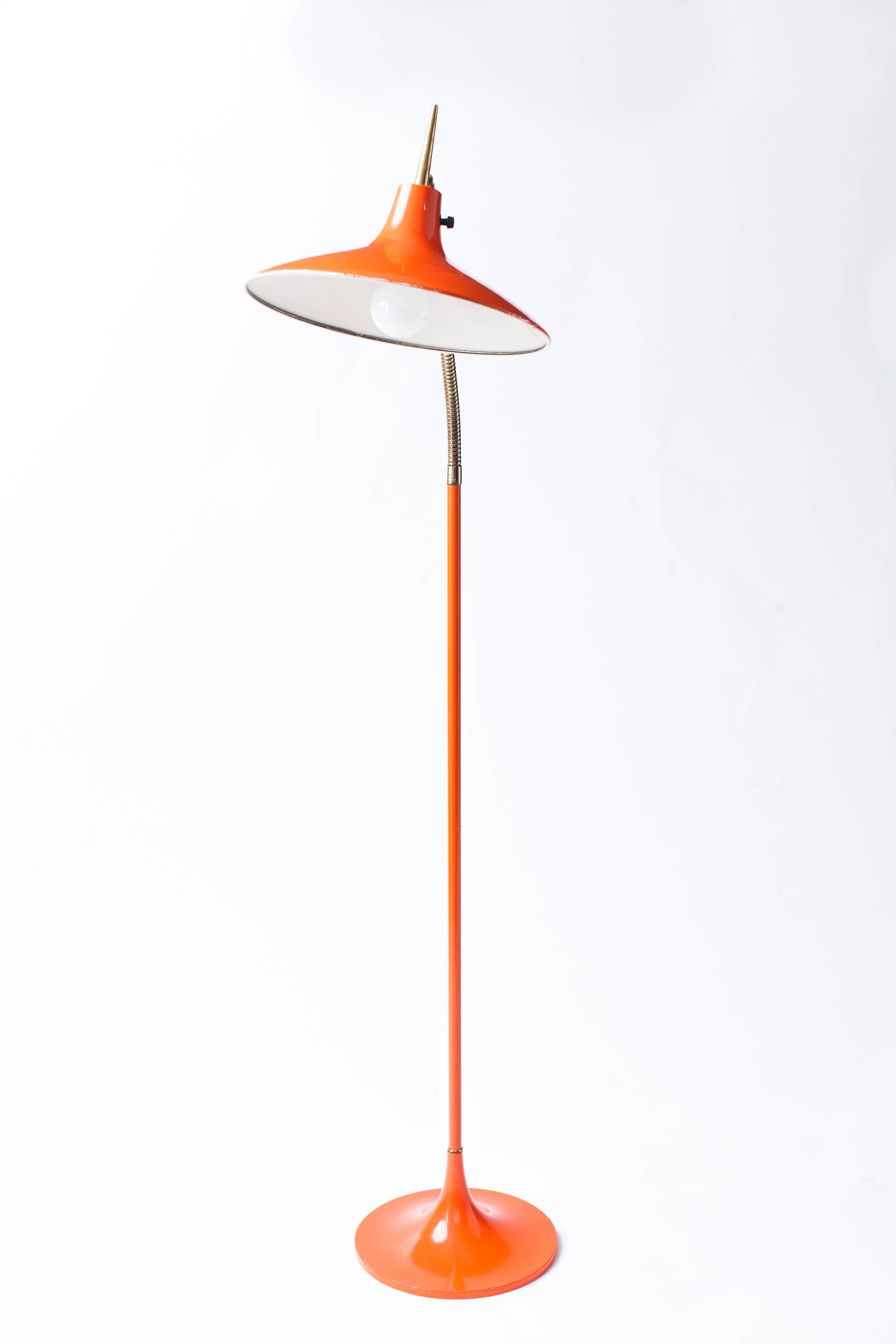Graceful and sleek Mid-Century Modern floor lamp for Laurel, in the style of Gio Ponti, with an articulated brass gooseneck and adjustable shade, enameled in a warm, deep orange.