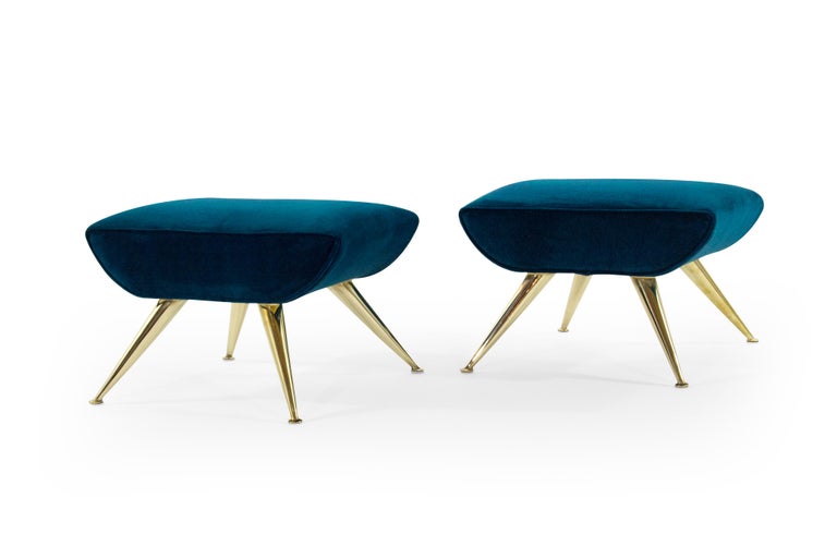 A set of footstools featuring hand polished solid brass legs, newly upholstered in aqua velvet by Holly Hunt, circa 1950s.