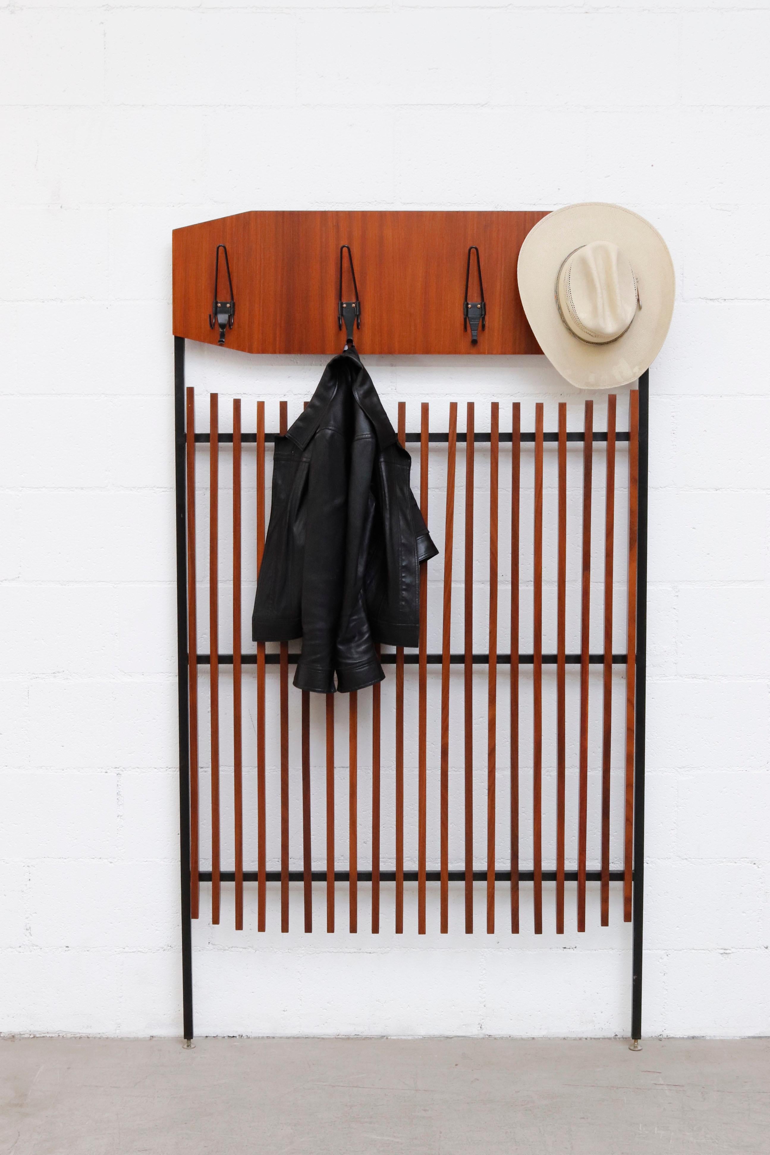 Gio Ponti style teak and metal Italian wall mount coat rack with leveling feet. Lightly refinished in good overall condition with new mounting cleat.