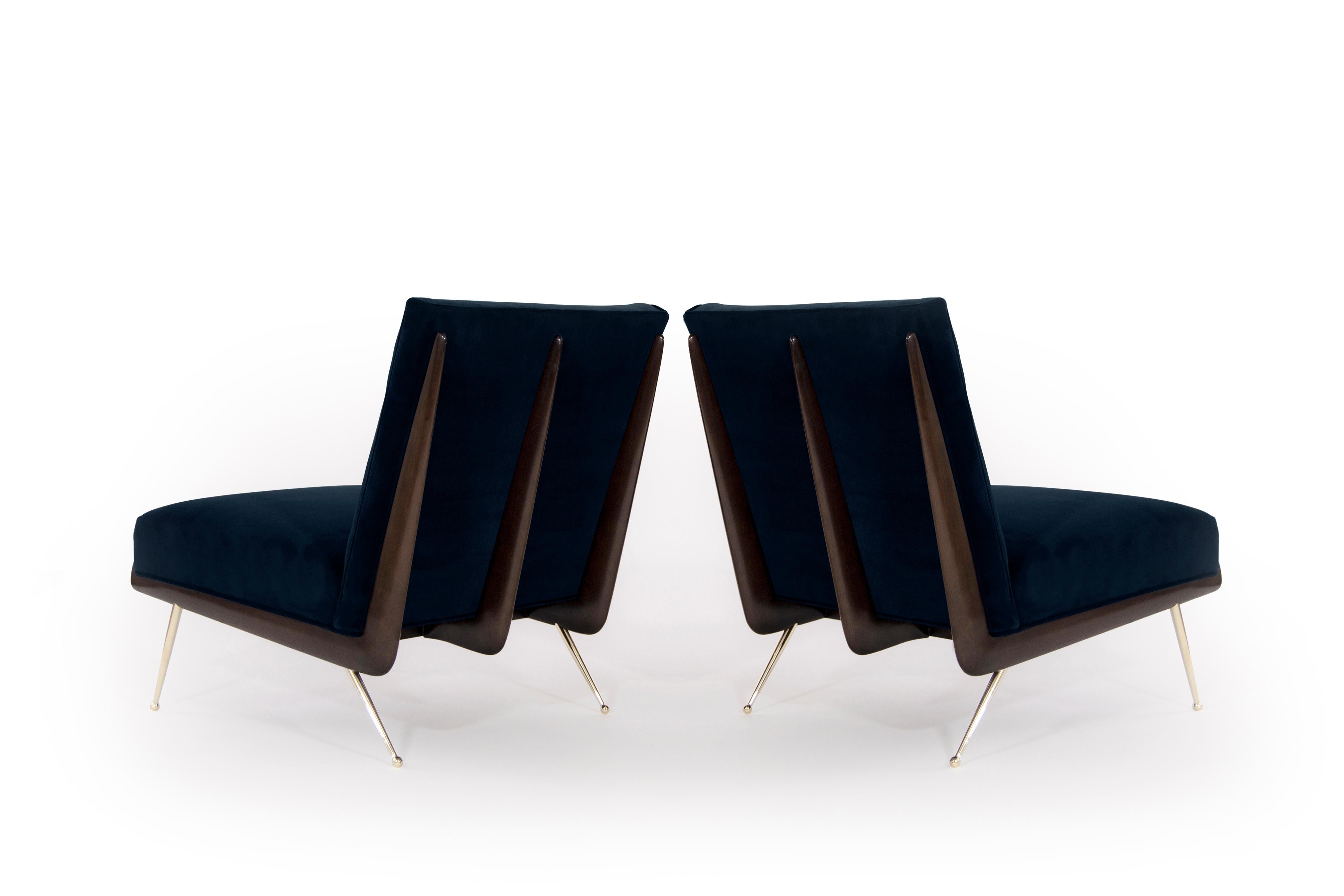 A phenomenal pair of lounge chairs, circa 1950s.

Boomerang shaped walnut frames fully restored to their original finish, newly upholstered in deep blue mohair. Thin tapered brass legs newly polished.