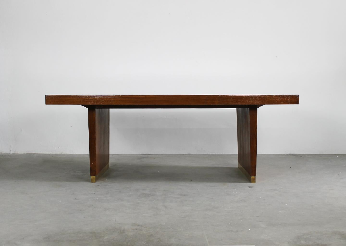Large table or desk with structure in oak wood, tabletop in red laminate and brass details. 
Designe by Gio Ponti, Italian manufacture from the 1950s.

Gio Ponti was an icon of the modernist movement: the Italian designer, architect, artist and