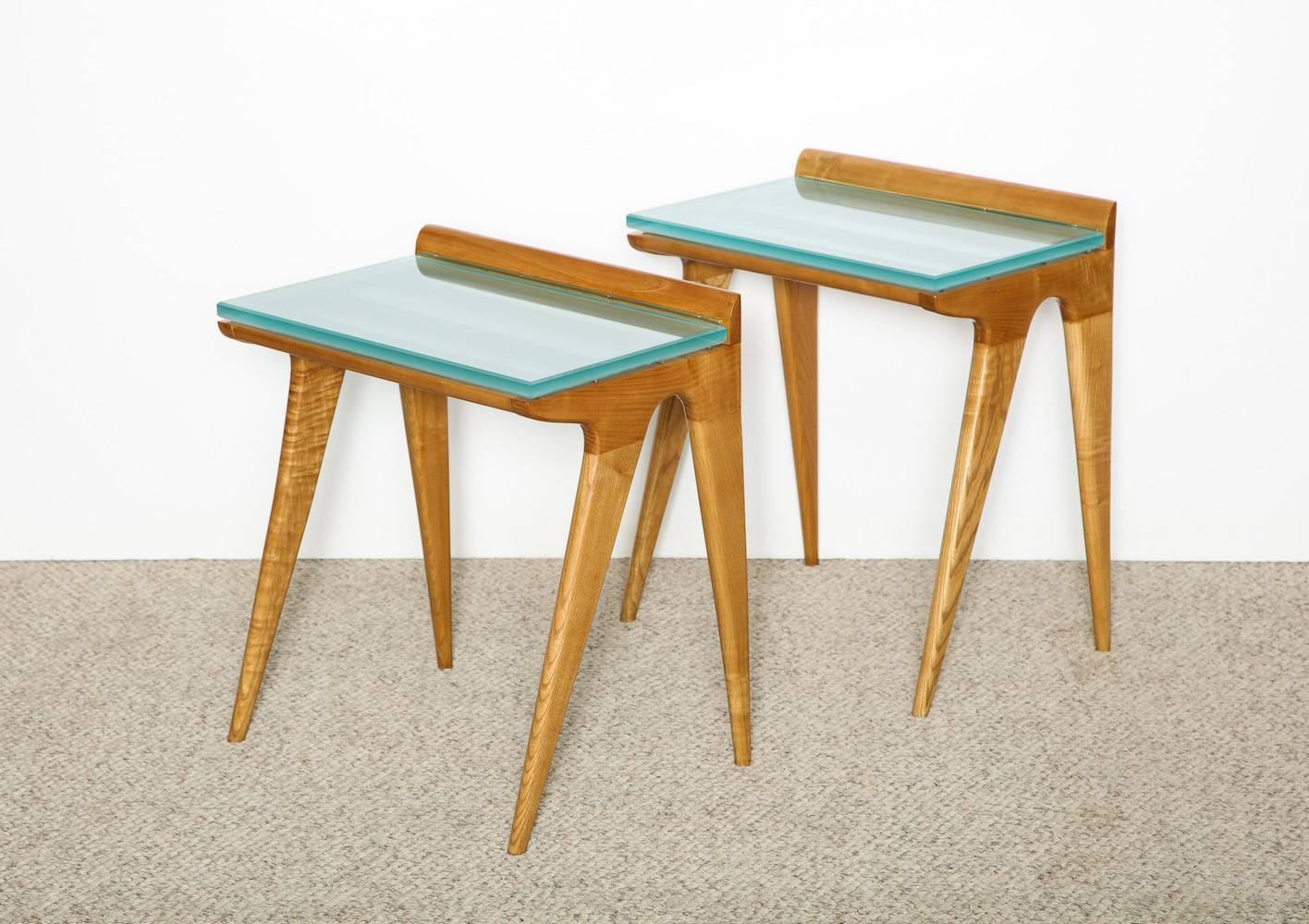 Custom side tables by Gio Ponti. Originally designed as petite luggage stands for a hotel outside of Florence. Bleached ash-wood, with brass runners and newly-made slab glass tops with frosted undersides. Great architectural forms in excellent