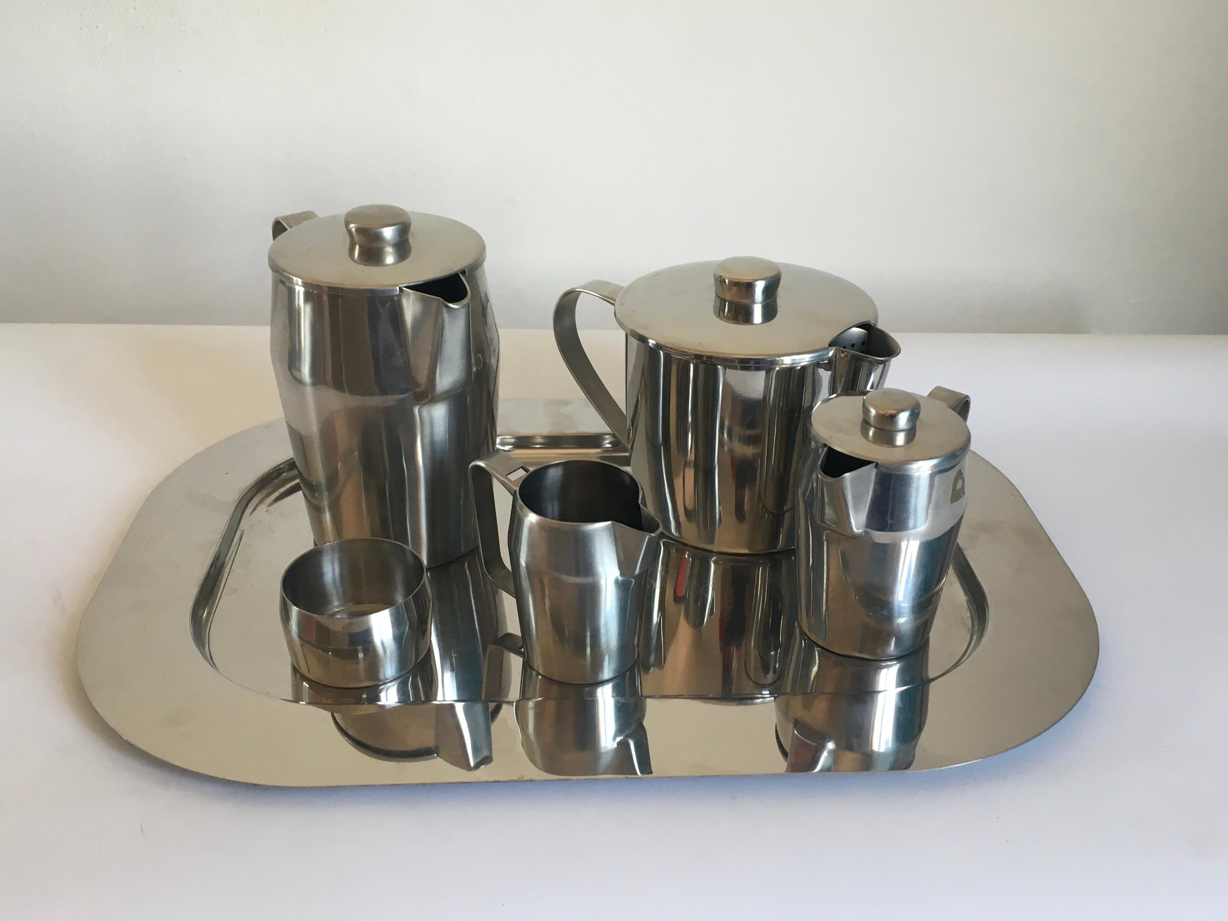 Tea set steel six pieces designed by Gio Ponti for Sambonet, 1970.
Dimensions:
Milk jug 18 cm H x W 20 cm x D 12 cm
Teapot 15 cm H x W 25 cm x D 16 cm.
    