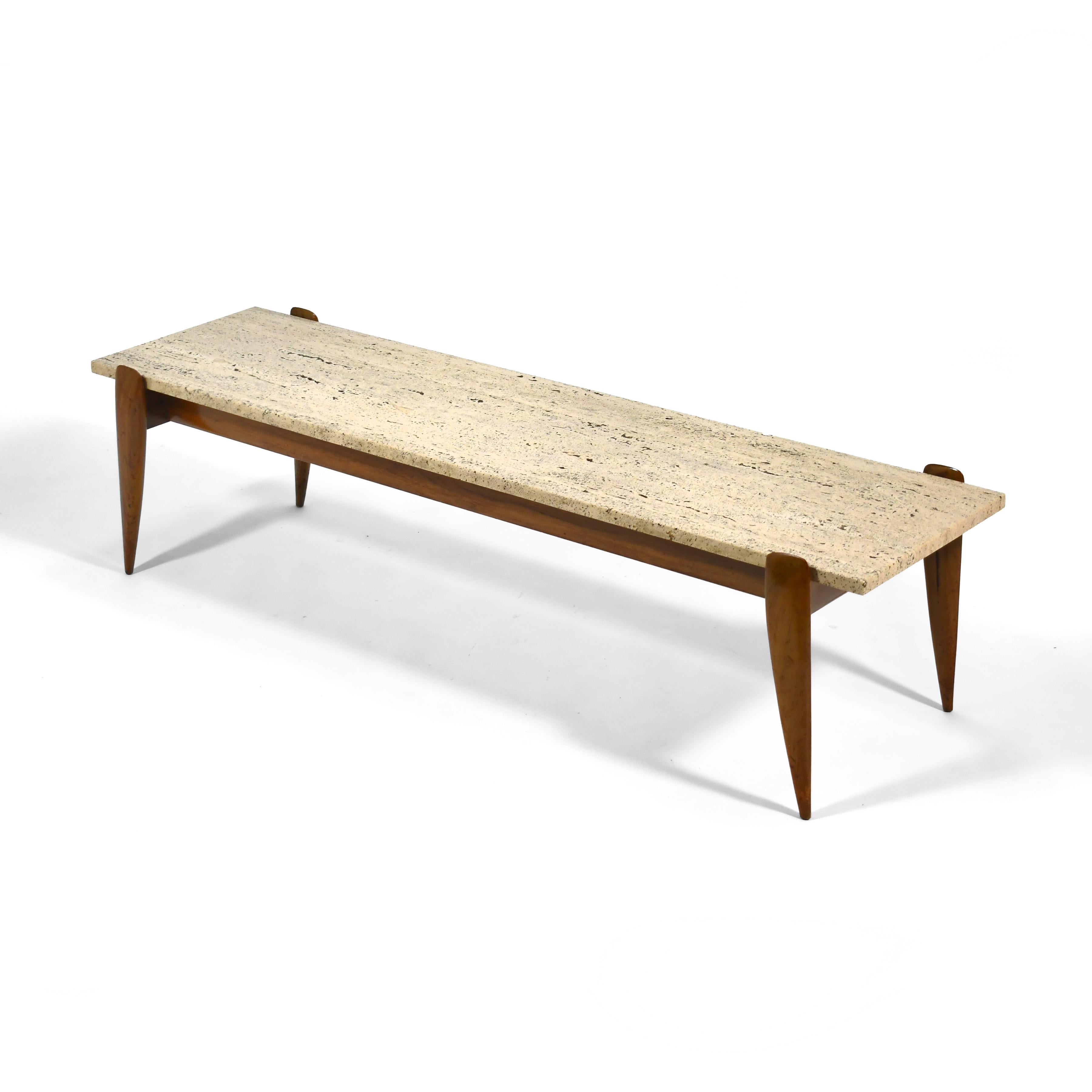 Sublime mid-century Italian design at its best, this coffee table by Gio Ponti by Singer & Son features a stunning piece of travertine marble supported by an Italian walnut base with elegantly sculpted legs. Acquired directly from the original