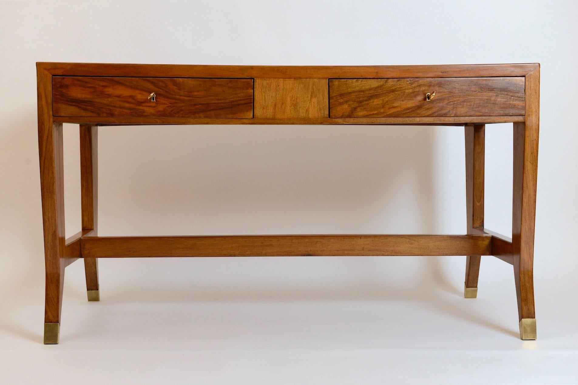 A stunning two-drawer walnut writing desk by one of Italy’s greatest architect and designers, Gio Ponti. Designed for the University of Padova, this substantial piece features a beautiful decorative back panel along with Ponti’s signature turned out