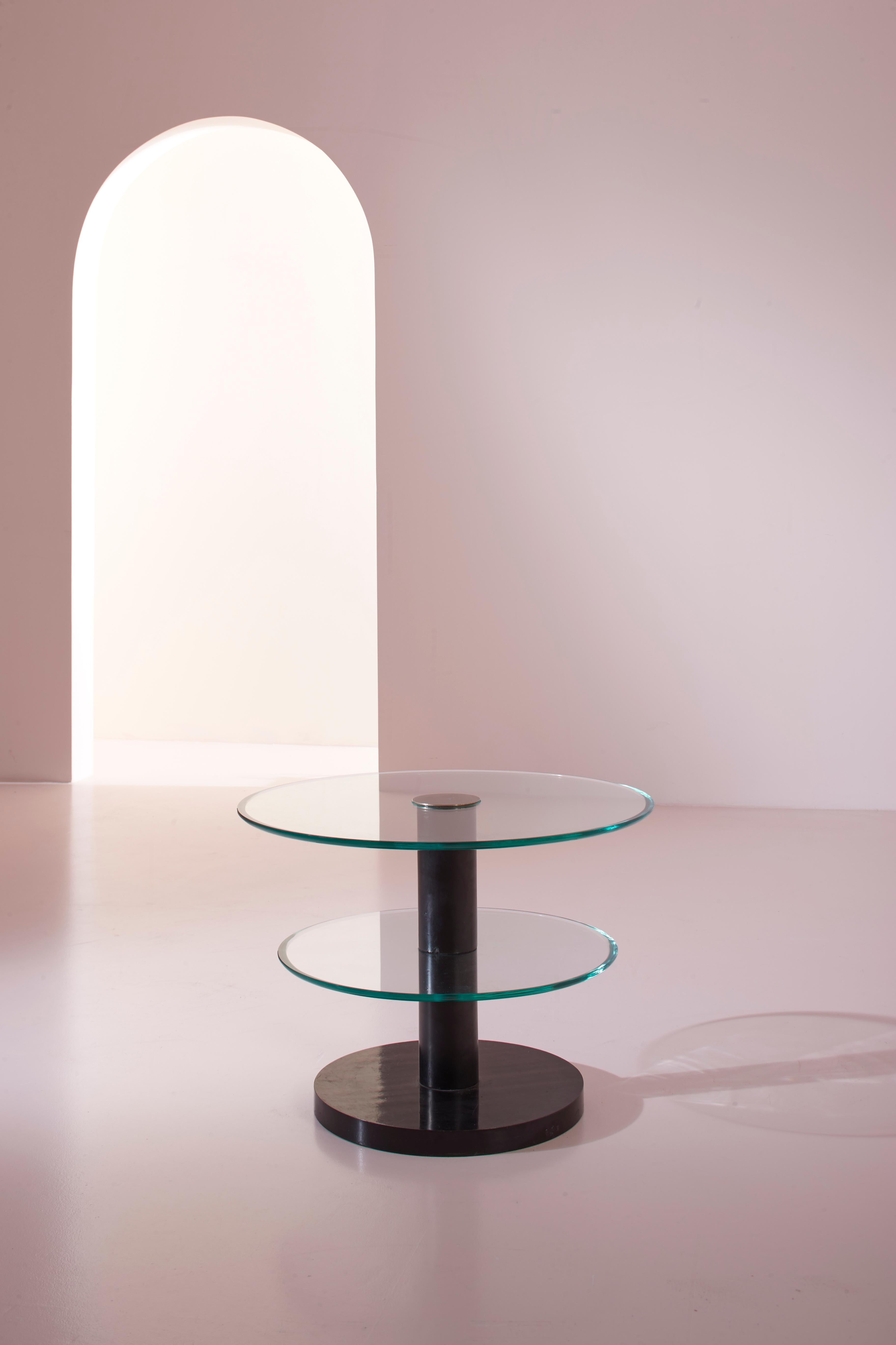 An occasional table with a black lacquered wood base and ground glass tops, designed by Gio Ponti in 1932 and produced by the Italian company Luigi Fontana & C.

This side table, though small in size, embodies the era when international aesthetic