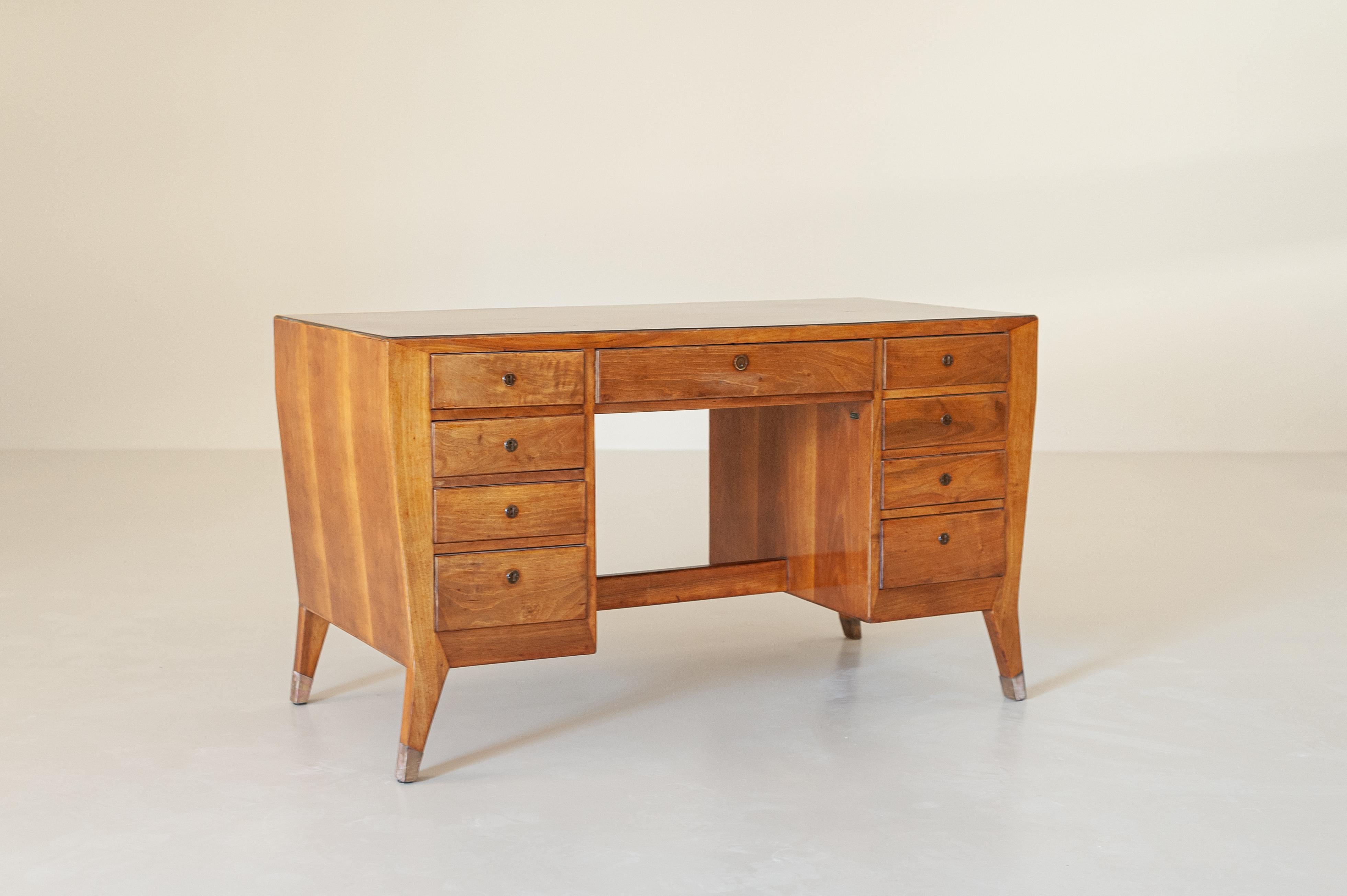 A rare and collectable walnut desk with brass ferrules designed by Gio Ponti and produced by Schirolli (Mantova - Italy) in the 1940s for the Banca Nazionale del Lavoro (BNL - National Bank of Labour).
With 4 drawers on each side of the desk and a