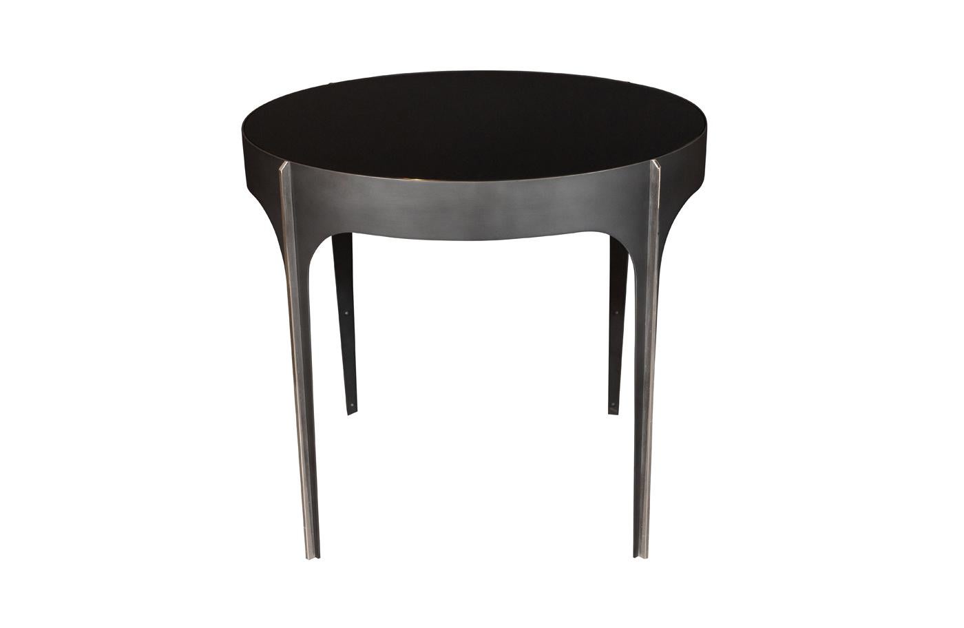 Blackened steel with polished nickel detail and reverse painted black glass inset top.