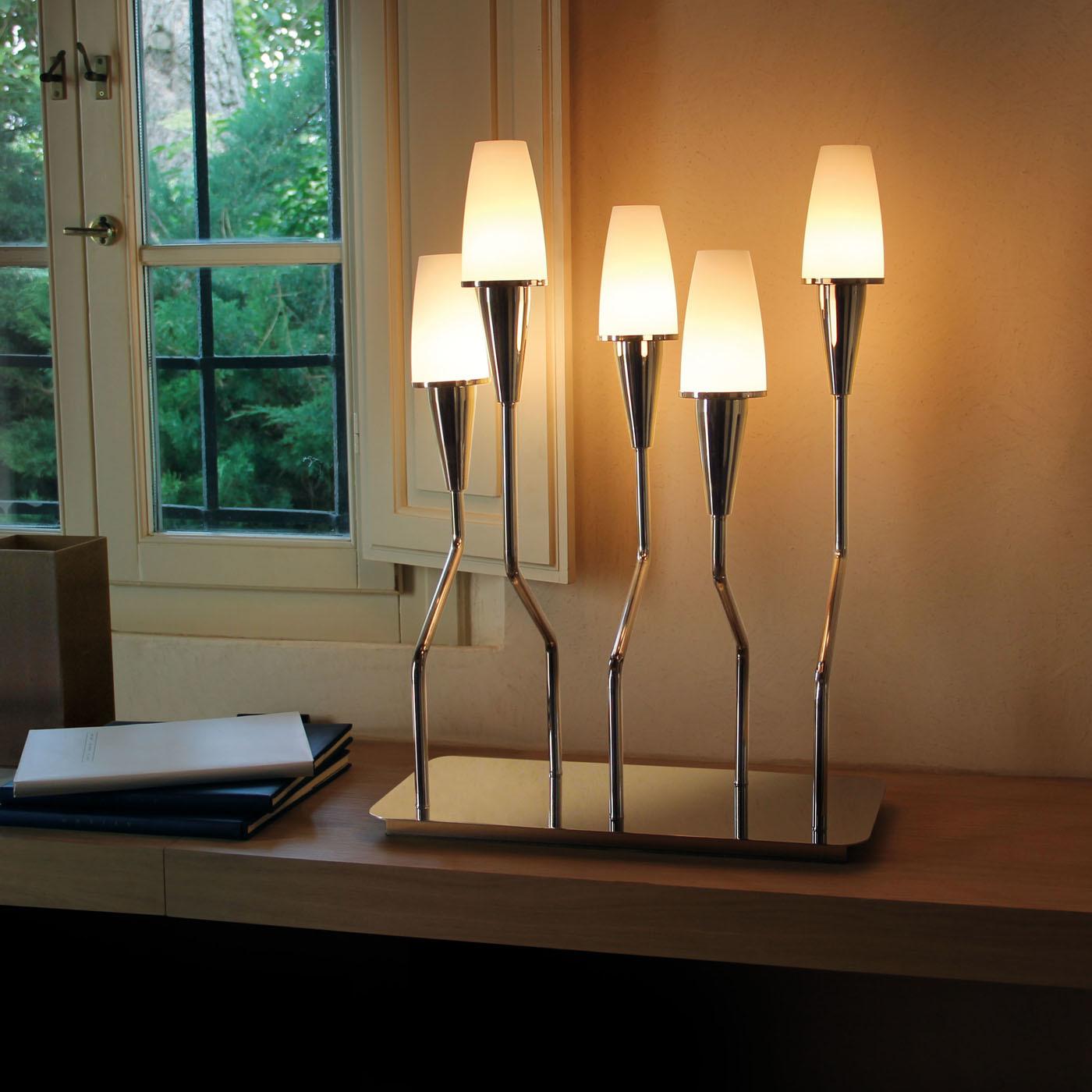 The dynamic design of the Gio table lamp brings a sophisticated and innovative element to the contemporary style decor in your home. The polished nickel brass base and arms combine beautifully with the diffusers in white acid-etched glass.\nBulbs: 5