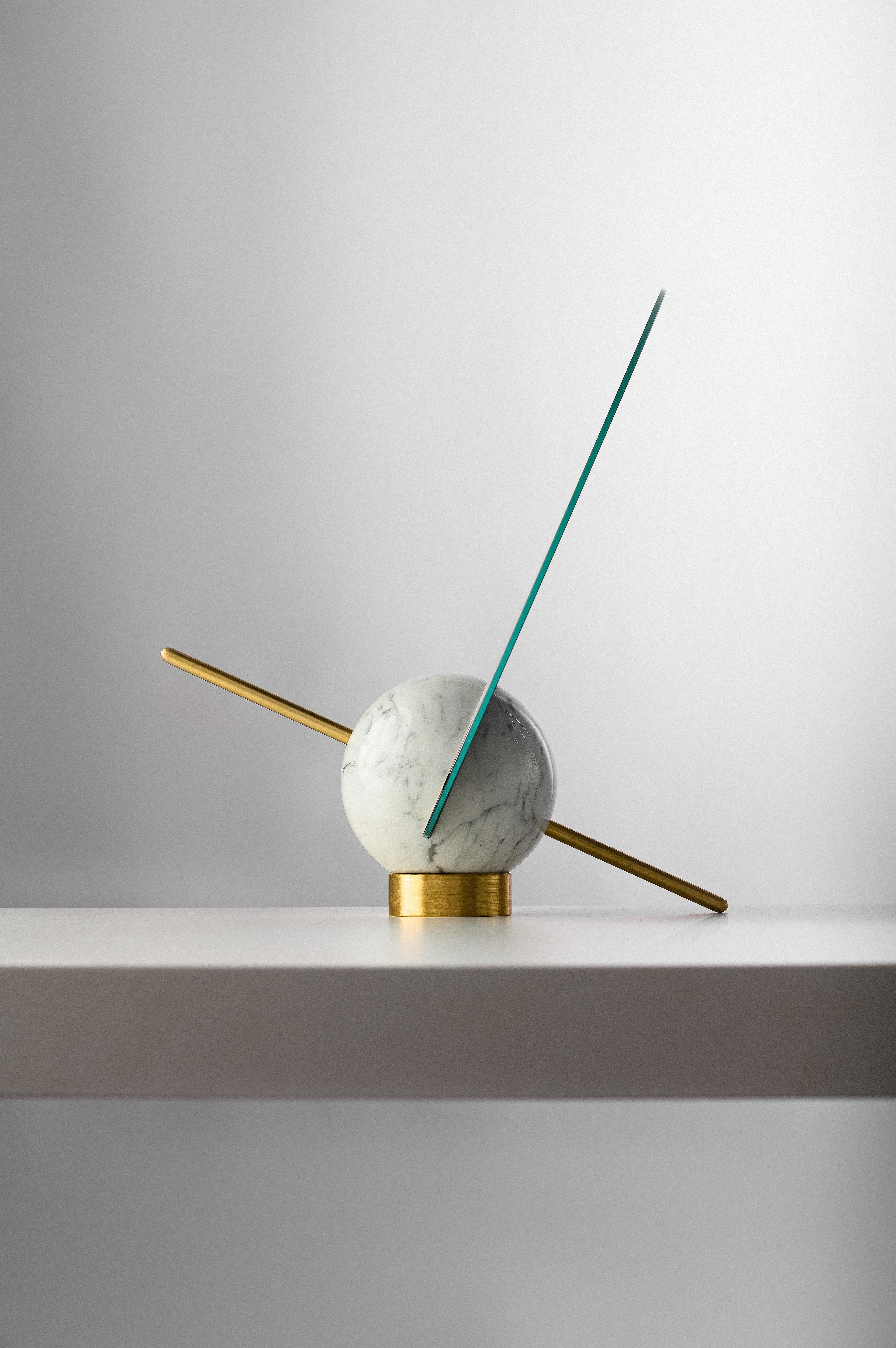 Gioco is a small standing mirror. 
It consists of a mirrored disk, a brass javelin and a round marble weight. Just as the art and skills of the participants are measured in different disciplines in The Games, Gioco proposes to challenge the