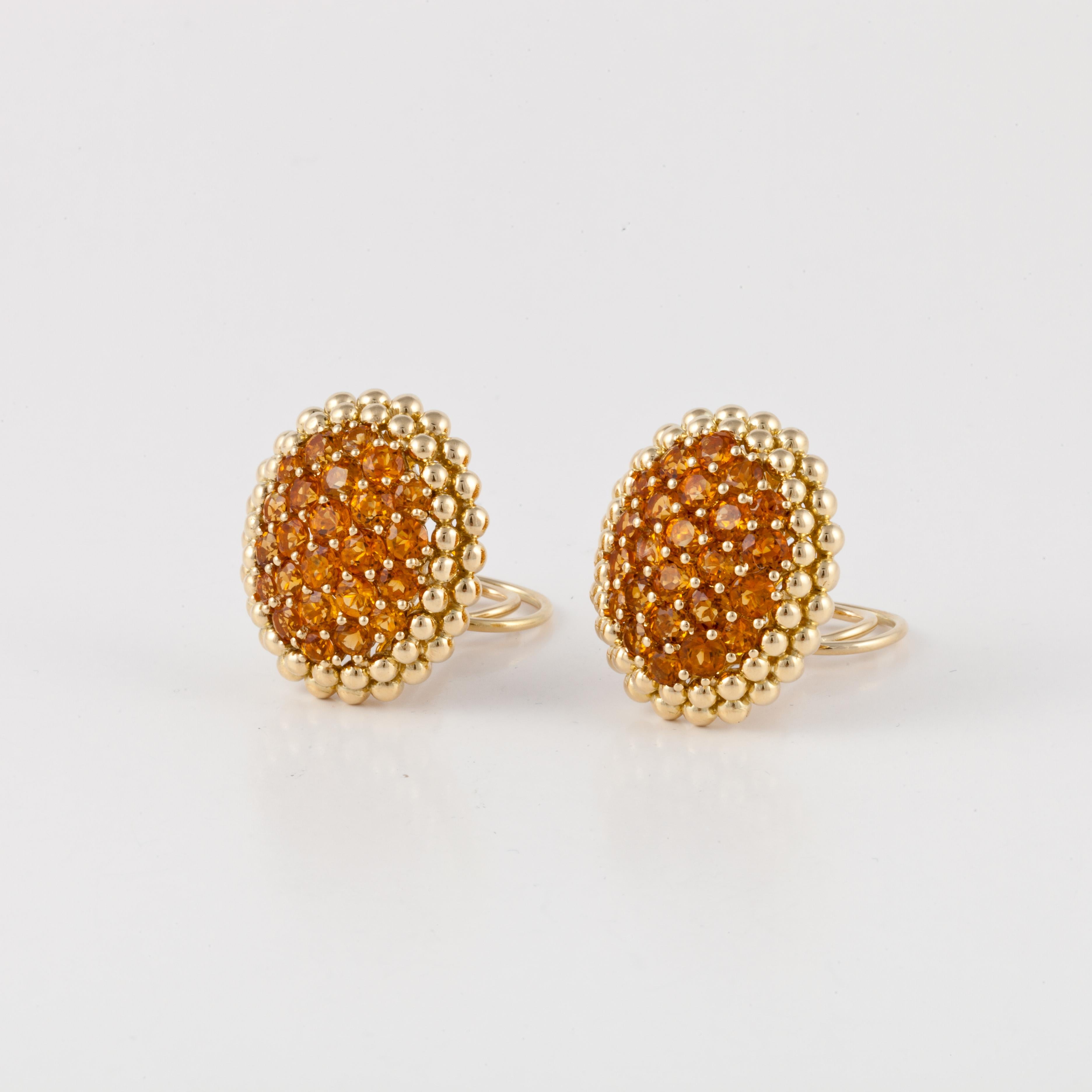 18K yellow gold citrine cluster earrings by Gioeil Moda.  The earrings feature 50 prong-set round citrine stones with a double frame of gold beads.  They measure 1 1/8 inches by 7/8 inches.  Clip-on style. 