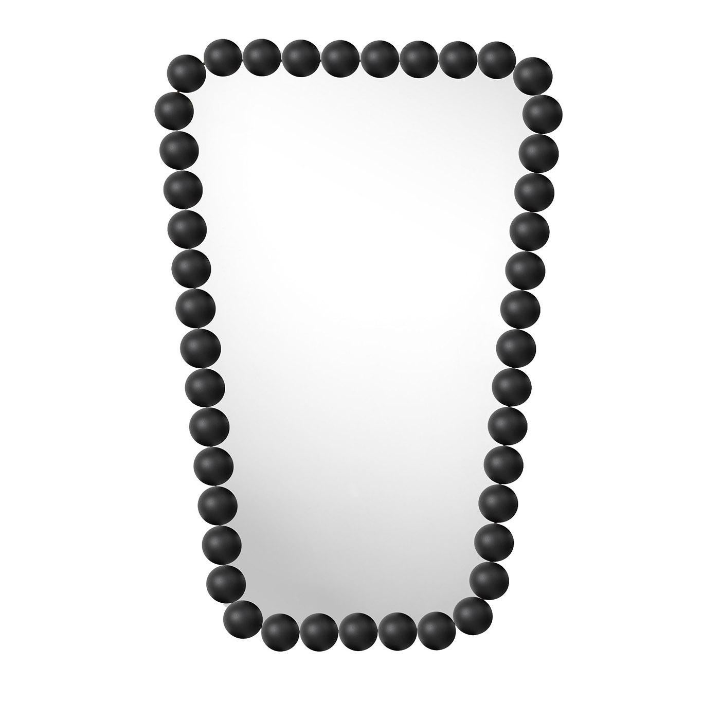 Reminiscent of a shaped, rigid necklace made of elegant beads, this wall mirror is a stylish design by Nika Zupanc. Its standout feature is its geometric inspiration, firstly revealed by the trapezoid shape and further emphasized by the frame, which