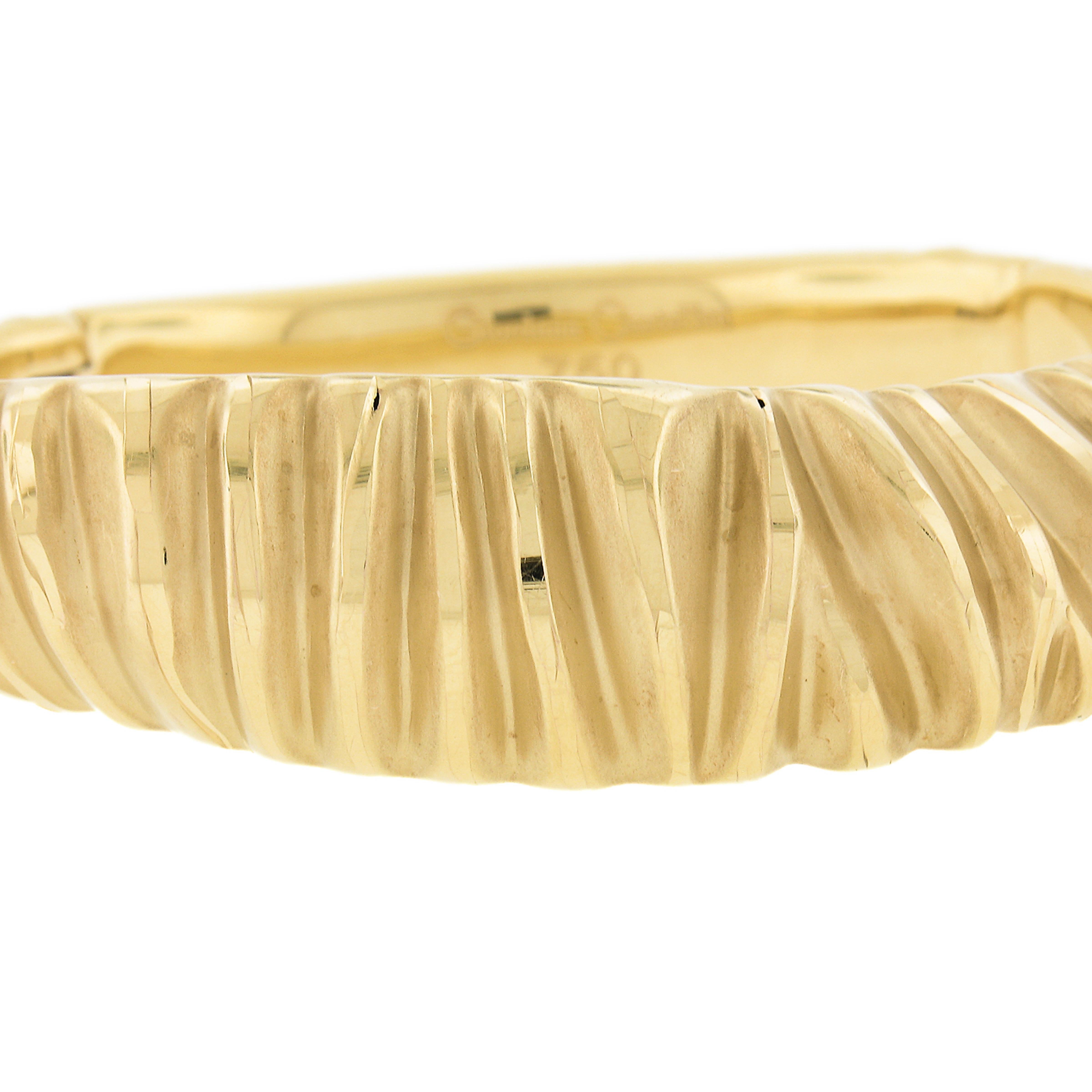 Material: Solid 18K Yellow Gold
Weight: 21.04 Grams
Type: Hinged Open Bangle Bracelet
Length: Will fit up to a 7 inch wrist (fitted on a wrist)
Clasp: Push Clasp w/ Safety Latch
Width: 18.2mm (0.71
