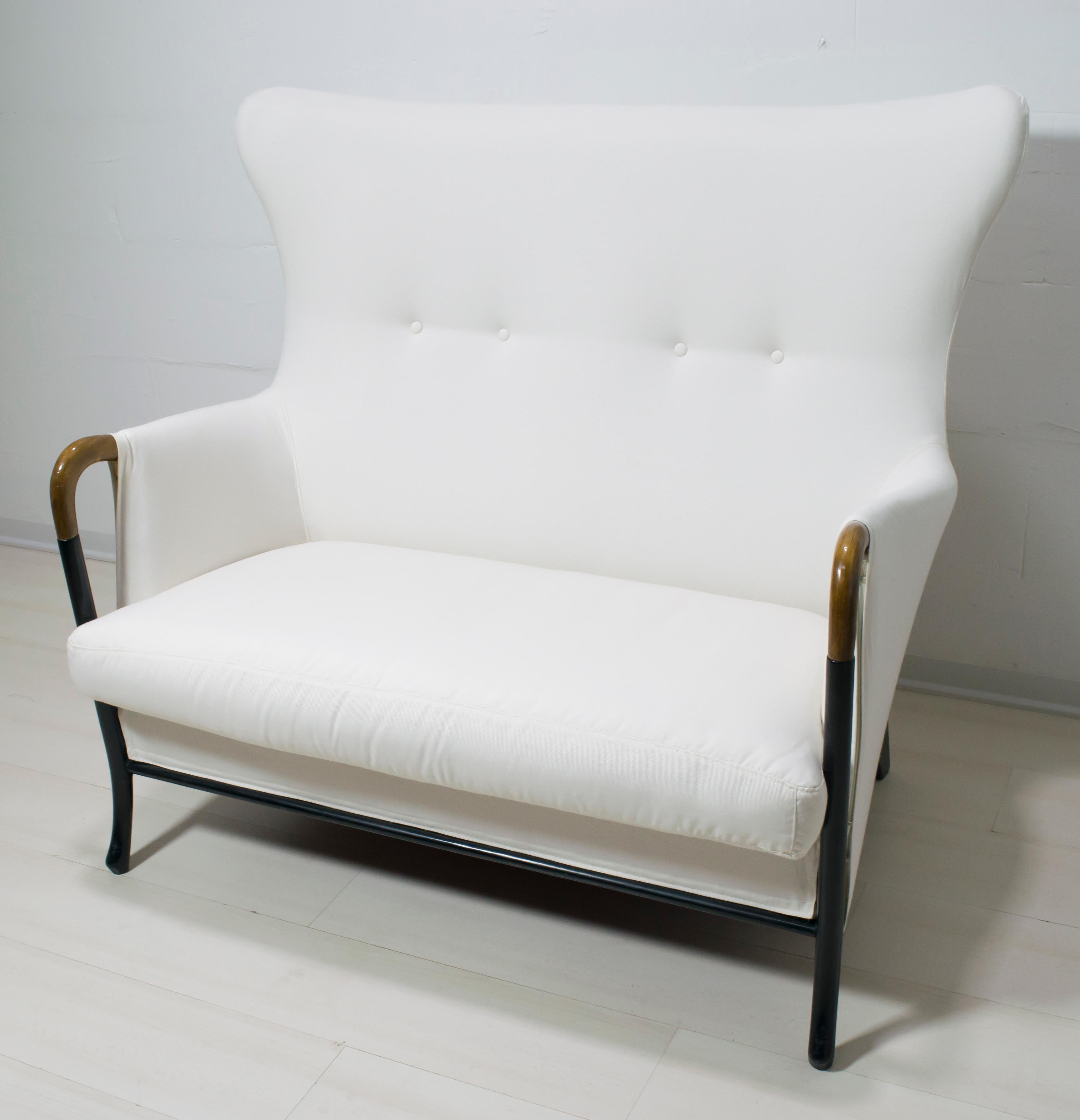 This sofa is in solid lacquered beechwood and polished Pau Ferro armrests, the seat and backrest padding is in polyurethane foam, and the cover is in cotton and completely removable. 
Founded by Luigi Giorgetti in 1898 in Brianza, the Italian