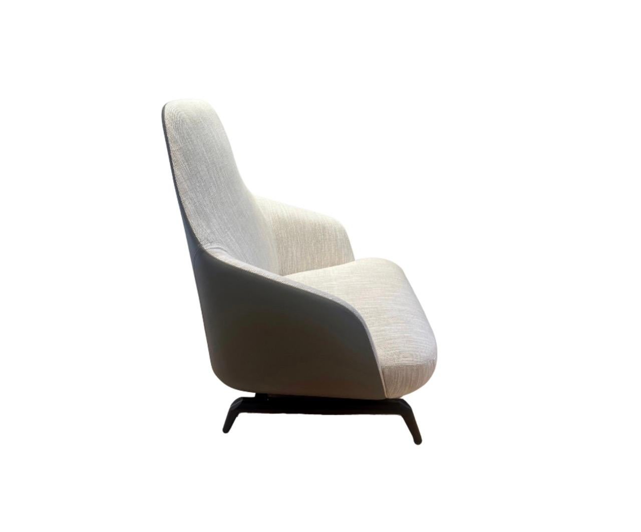 Designed by Umberto Asnago

Janet High Back Armchair 97828
-Inside in fabric cat. C Penny, 02 Sable
-Outside in pelle, 205
-Base in wood stained 2Z

This item is a floor sample. 