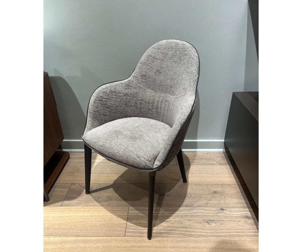 Small armchair with legs in leather and upholstery in fabric, with the external side in fabric and the internal one in fabric, with always a leather piping.

Fabric: Tinto 10611/905 ACIER
Piping and Feet wrapped in leather: Leather Testa Di Moro