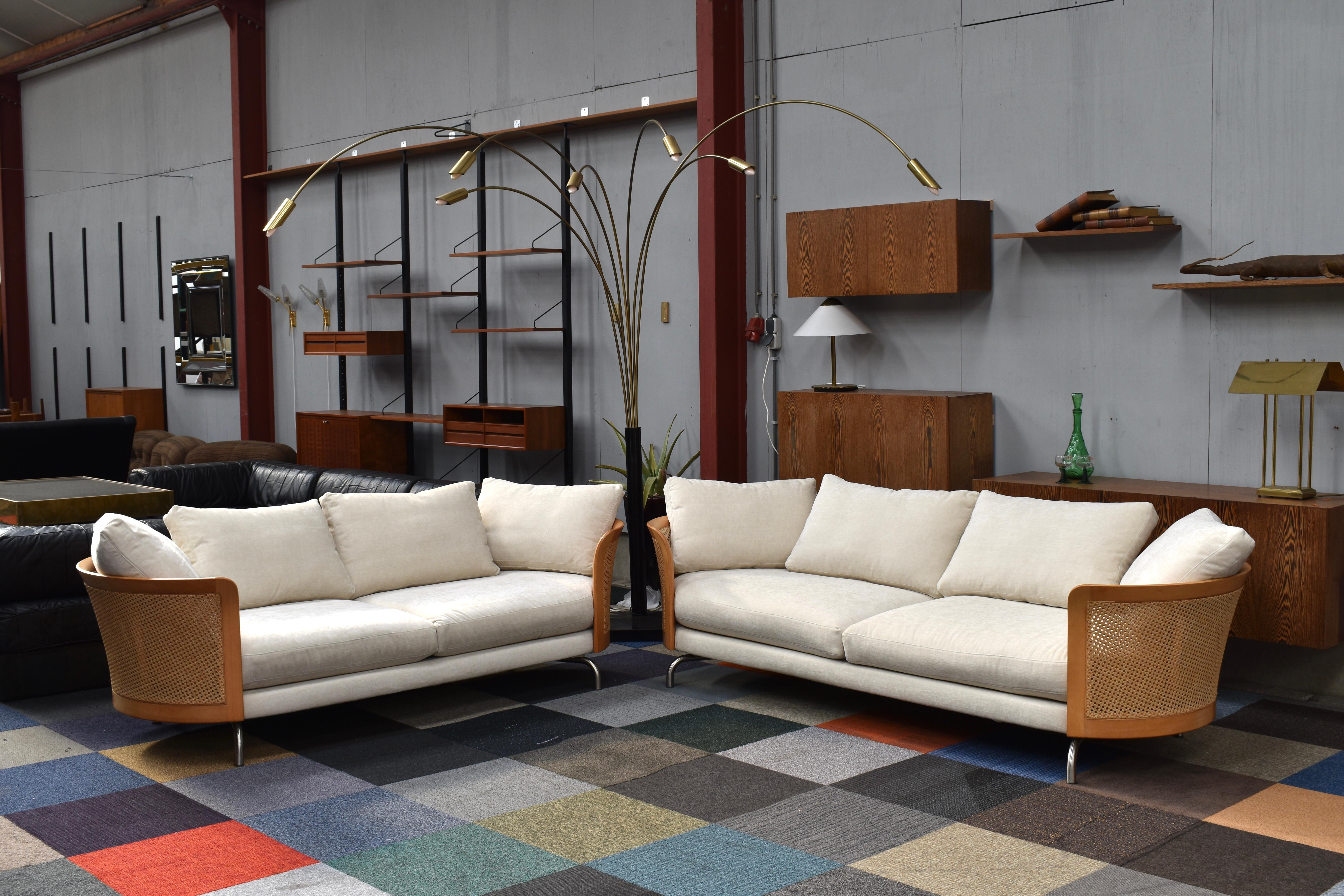 Pair of Virginia sofa’s by Giorgetti Italy (one large / one smaller sofa). This model is not in production anymore so hard to find. They are made of solid beech and rattan. The cushions have been reupholstered in a beautiful off-white (creme/ivory)