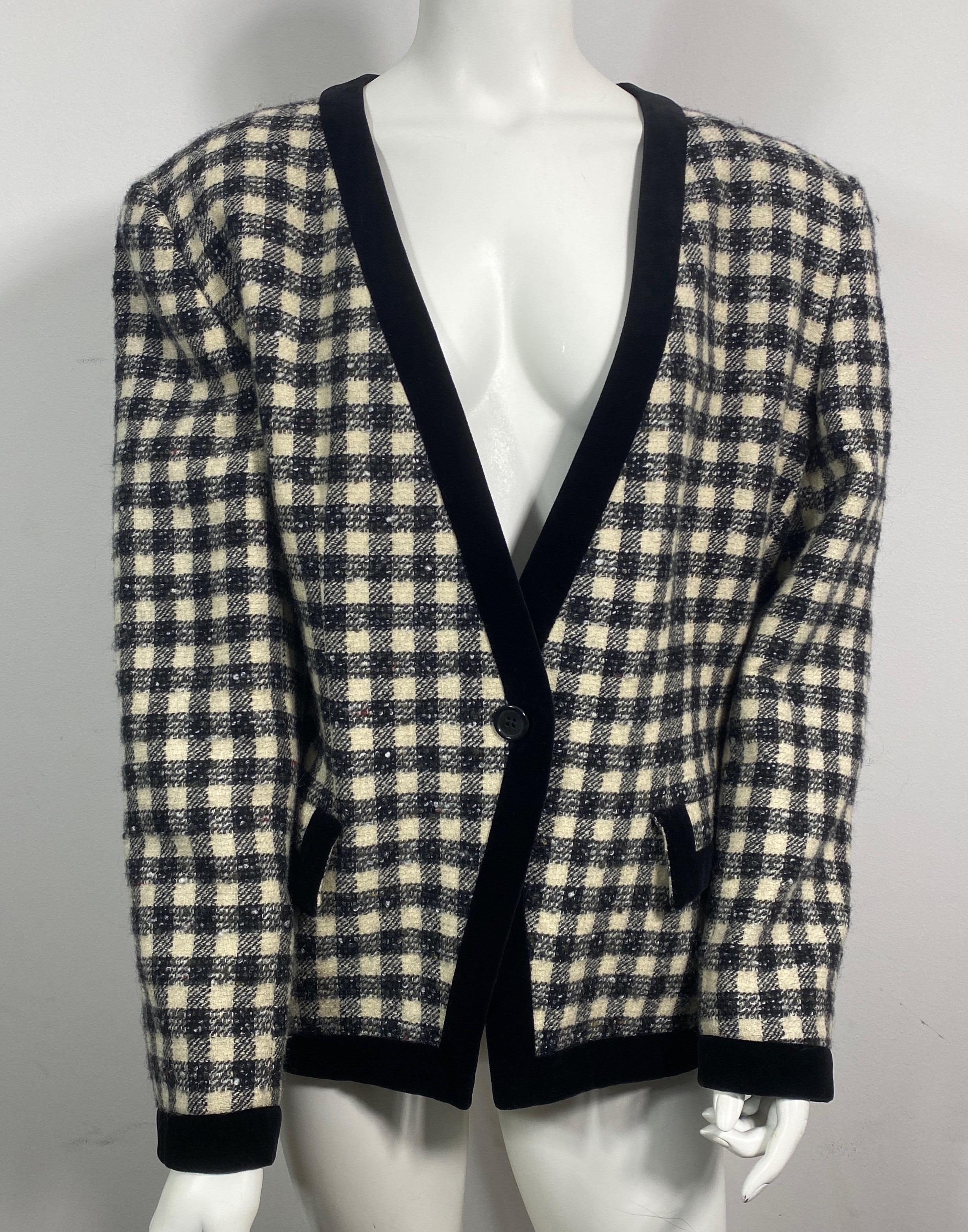 Giorgio Armani 1990’s Black and Ivory Tweed Checkered Jacket -Size 46  This 1990’s black and ivory Shepherd Check tweed jacket is full lined in a quilted silk like fabric and has a 1 “ black velvet trim throughout the jacket. The single breasted