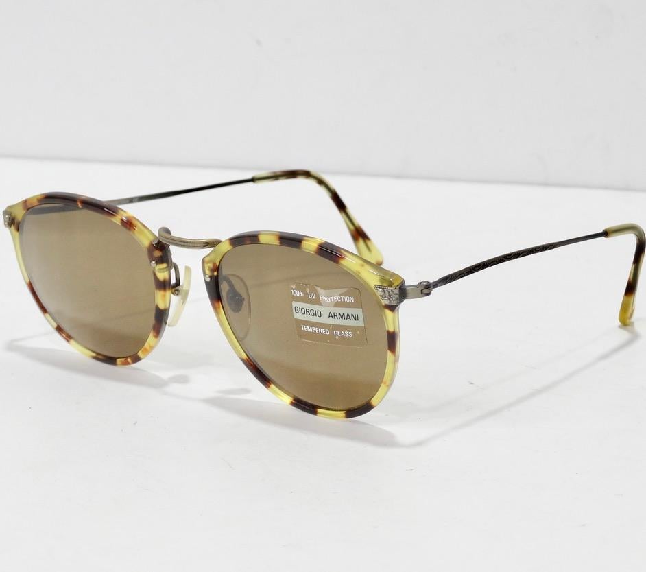 Elevate your eyewear this summer with these beautiful Giorgio Armani dead stock sunglasses circa 1990s! The perfect every day sunglasses featuring brown lenses accompanied by a stunning tortoise shell print and engraved silver tone detailing. These