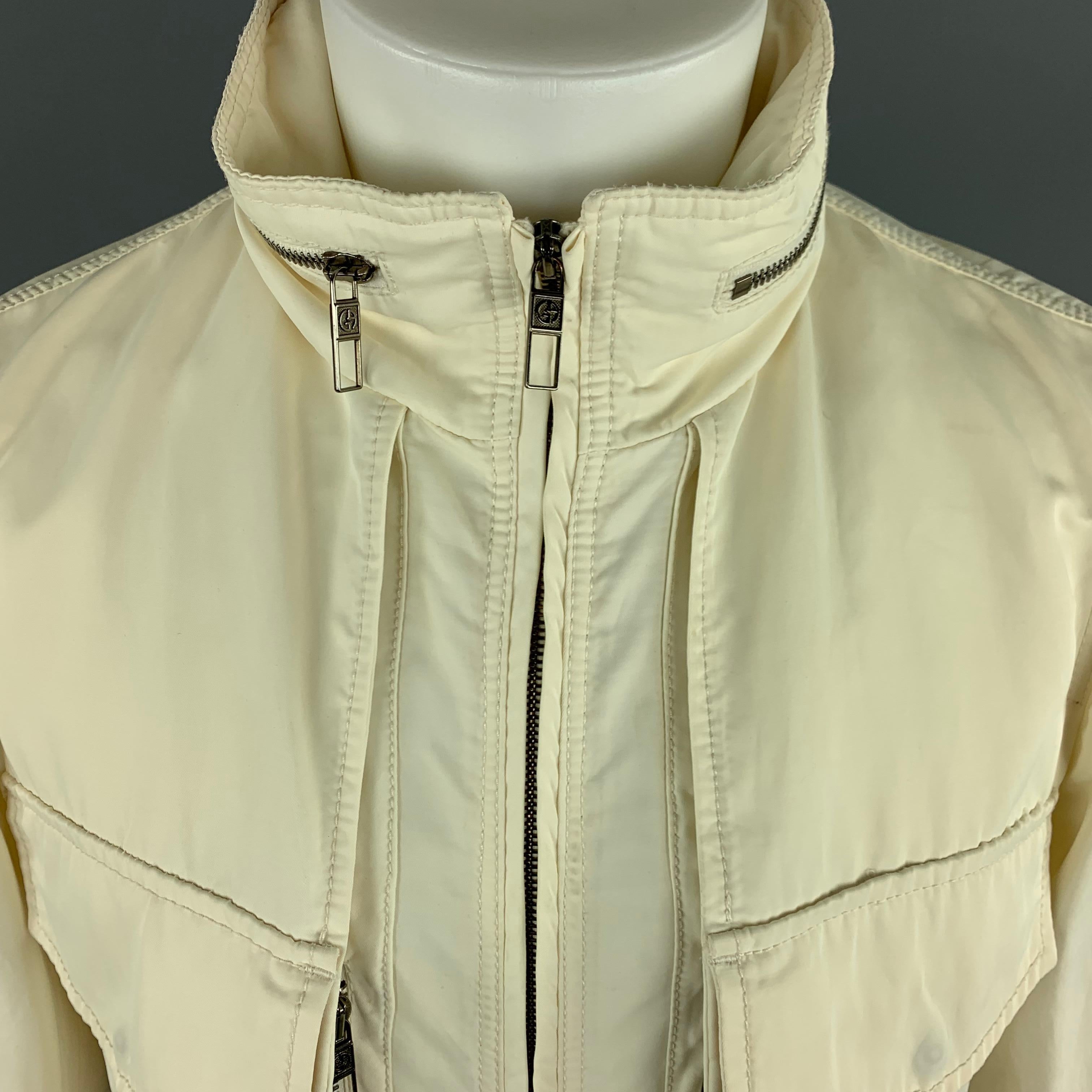 GIORGIO ARMANI Jacket comes in a cream tone in a solid cotton / nylon material, with a high collar, patch pockets, a hood, zip up. Made in Italy.
 
Excellent Pre-Owned Condition.
Marked: IT 48
 
Measurements:
 
Shoulder: 16 in.
Chest: 40 in.
Sleeve: