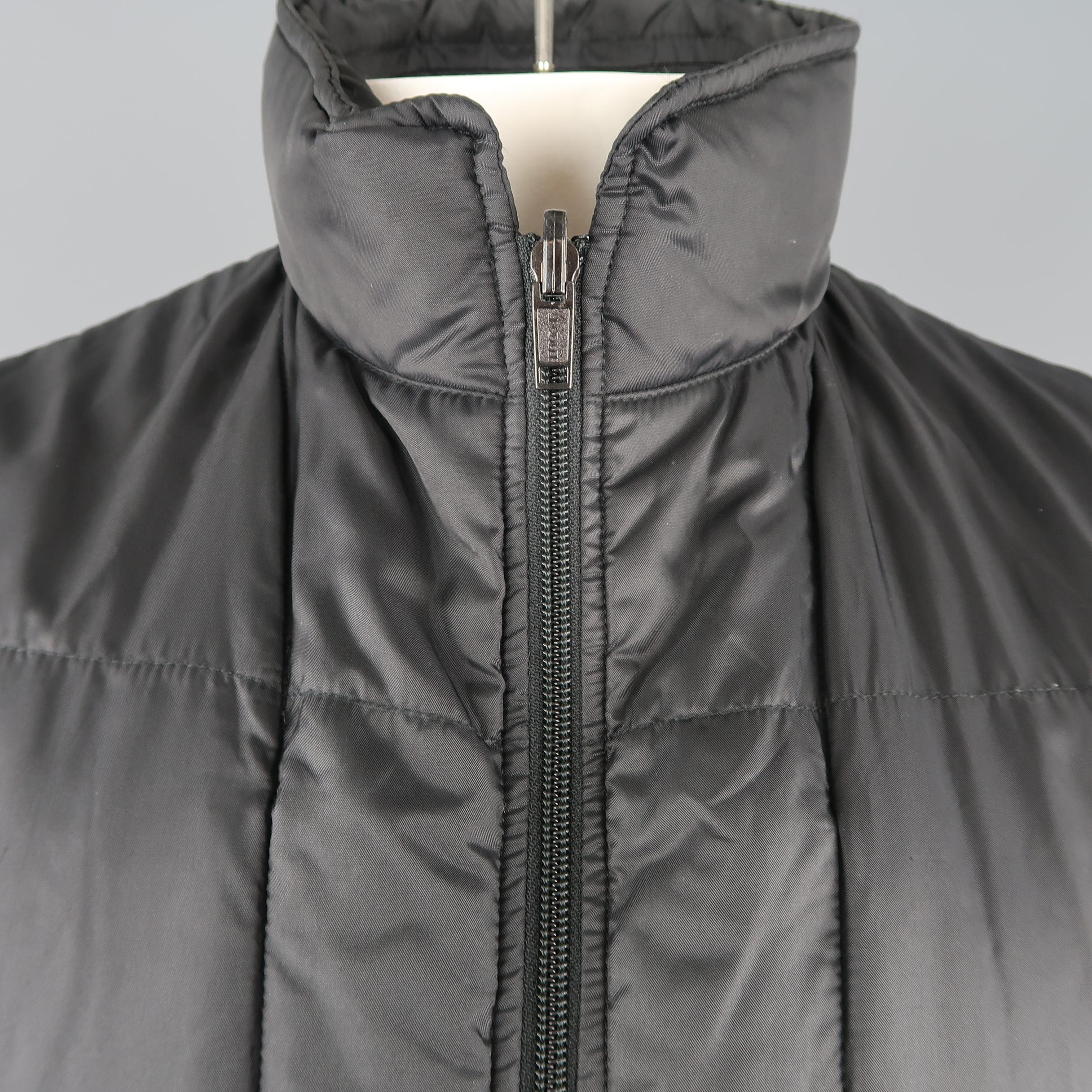 GIORGIO ARMANI vest comes in quilted nylon with zip pockets and high collar with zip out hood. Made in Italy.
 
Very Good Pre-Owned Condition.
Marked: 42
 
Measurements:
 
Shoulder: 18 in.
Chest: 48 in.
Length: 28 in.