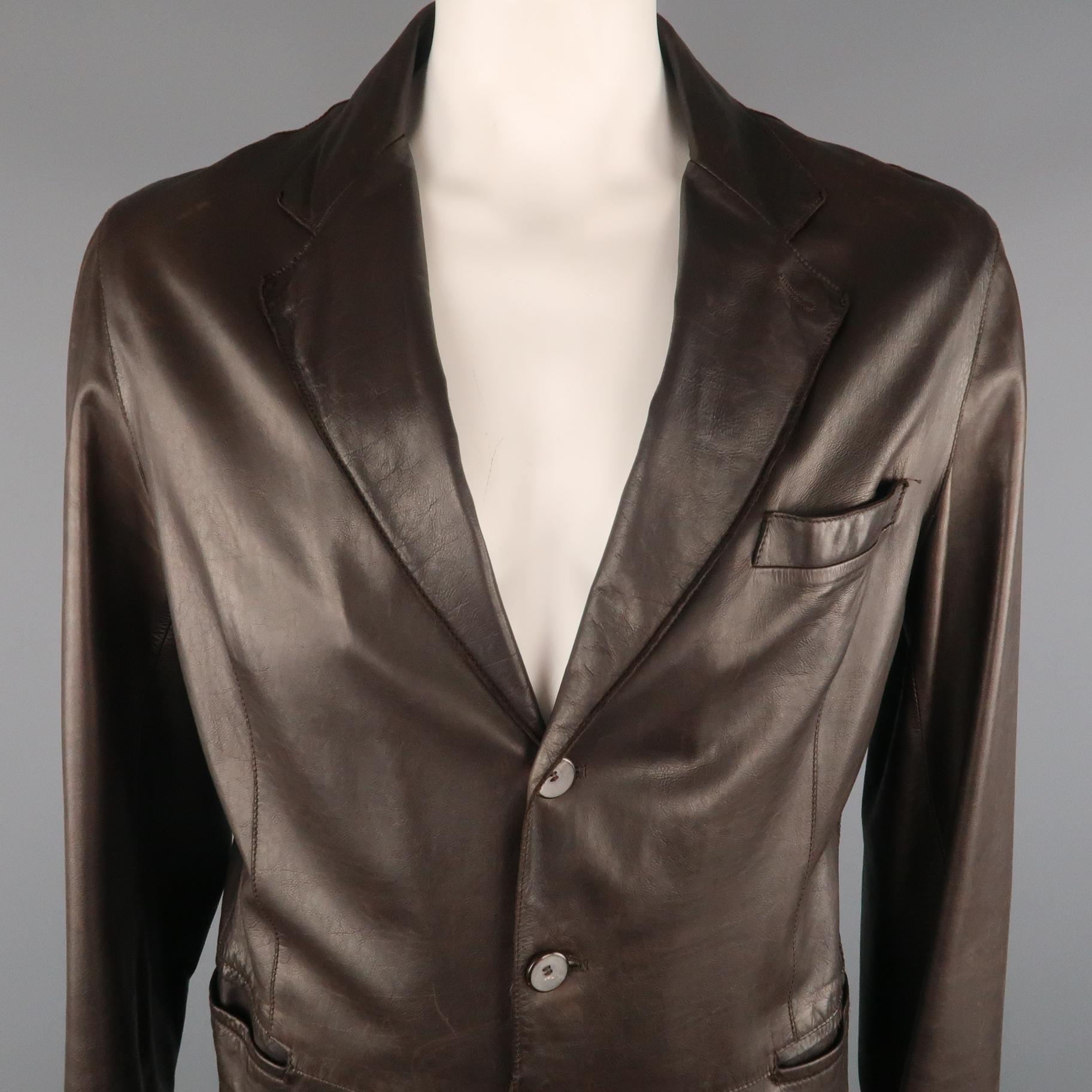 GIORGIO ARMANI Sport Coat comes in a brown tone in a solid leather material, with a notch lapel, slit pockets, 3 buttons at closure, single breasted, functional buttons at cuffs and a single vent at back. As Is. Made in Italy.
 
Good Pre-Owned