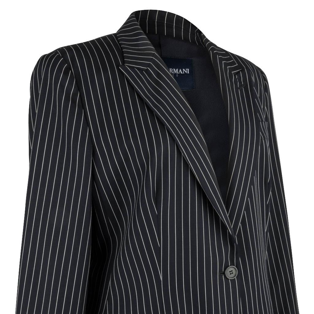 Giorgio Armani Classico pinstripe light weight single breasted jacket.
Pure Americana in deep navy blue with a white pinstripe.
Beautiful detail to the pinstripe  accentuates the cut of the jacket.
2 slit pockets still sewn shut.
3 buttons on each
