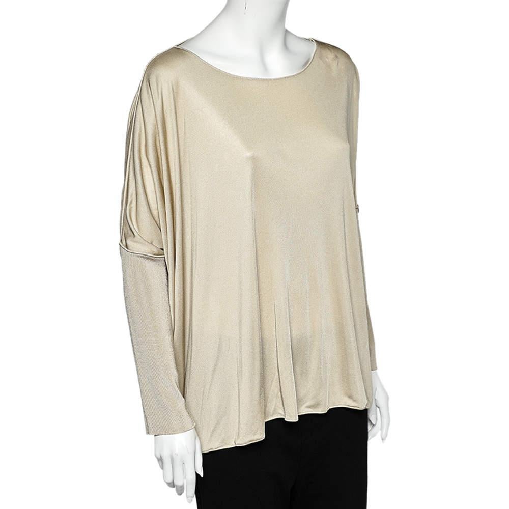 Renowned for its trendsetting designs, this top from Giorgio Armani is a must-have in your collection. It has been made from beige jersey fabric and flaunts an oversized fit and long sleeves. This top lends a fine and comfortable touch to your