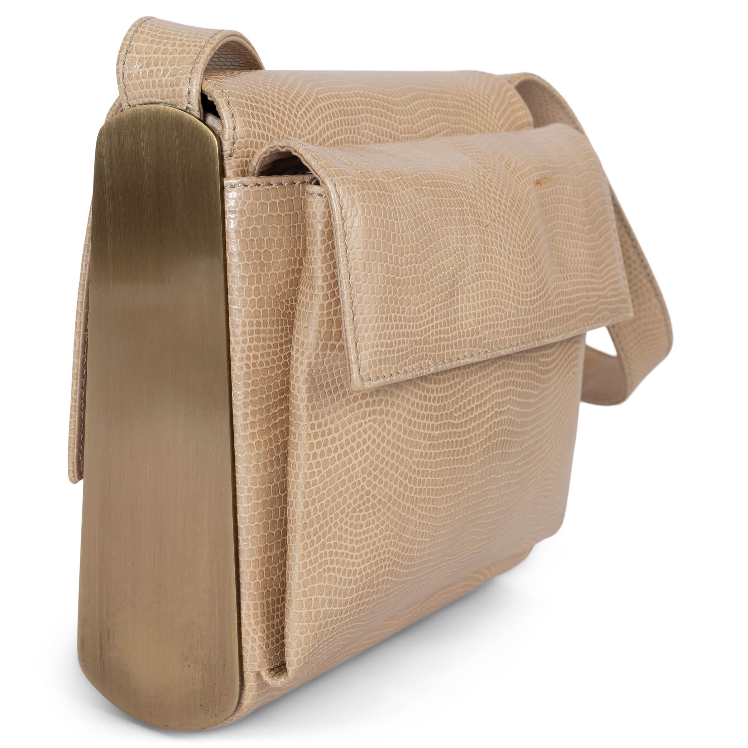 This 100% authentic Giorgio Armani evening bag is crafted from luxurious beige lizard, offering an elegant and sophisticated design. It features an exterior flap pocket and opens with a magnetic snap under the flap. The interior is lined in satin