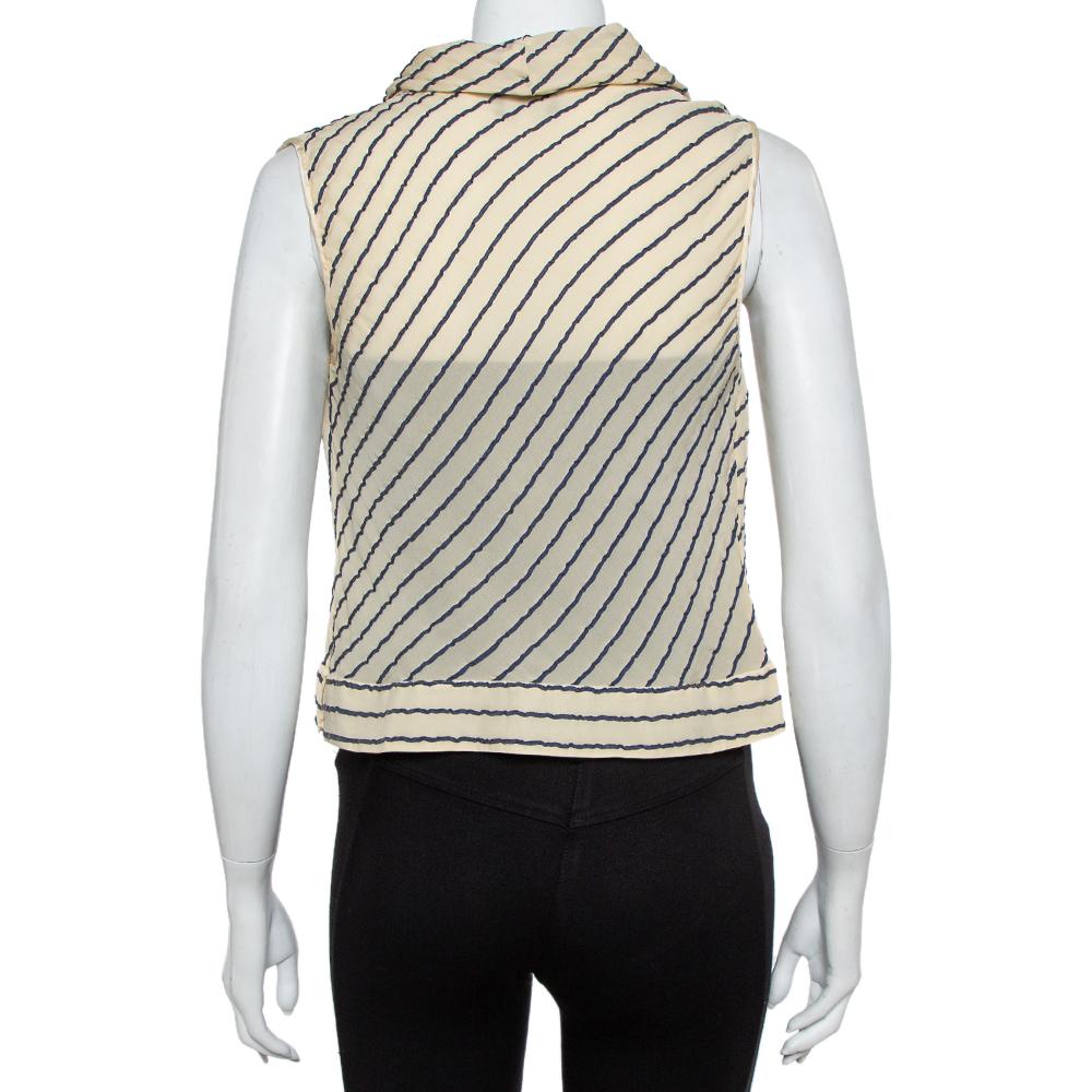Comfortable and chic, Giorgio Armani's top made from silk has a stylish appeal! Tailored beautifully, the top has a sheer effect, cowl neckline, and stripes all over. Team it with high-waist pants or skirts.

