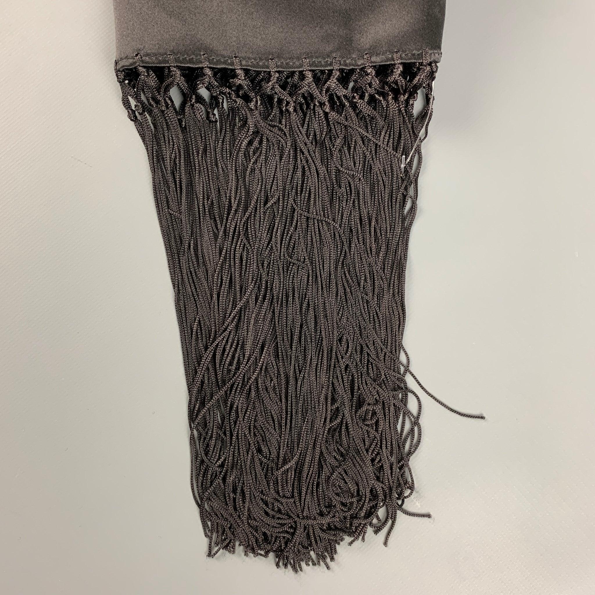 GIORGIO ARMANI scarf comes in a black abstract print satin material featuring an eight fringe trim.Very Good Pre-Owned Condition. 

Measurements: 
  27.5 inches  x 65 inches  
  
  
 
Reference: 126922
Category: Scarves & Shawls
More Details
   