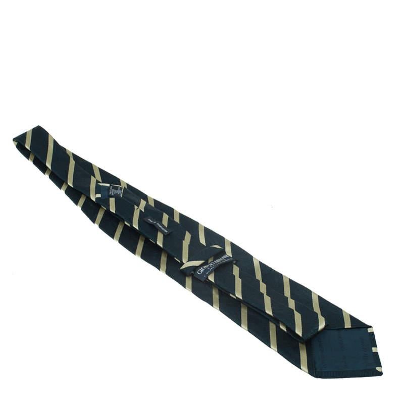 This classic tie from Giorgio Armani has a timeless appeal. Cut from a silk-cotton blend with stripes throughout, this black and beige tie will surely accentuate your charm.

