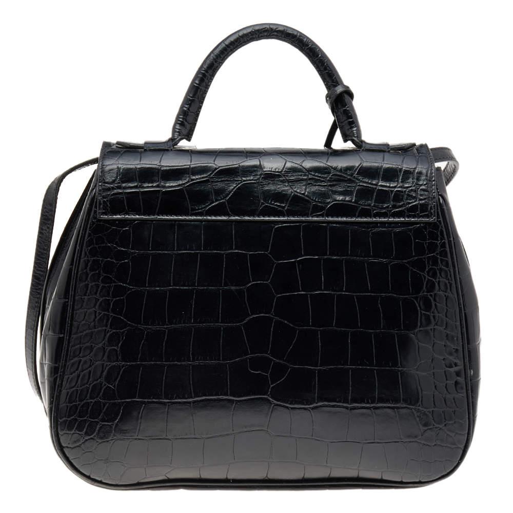 Made from croc-embossed leather, this bag is both reliable and stylish. It comes in a flap style with features such as a top handle, a shoulder strap, gold-tone hardware, and a lined interior. This bag from Giorgio Armani will be a fine