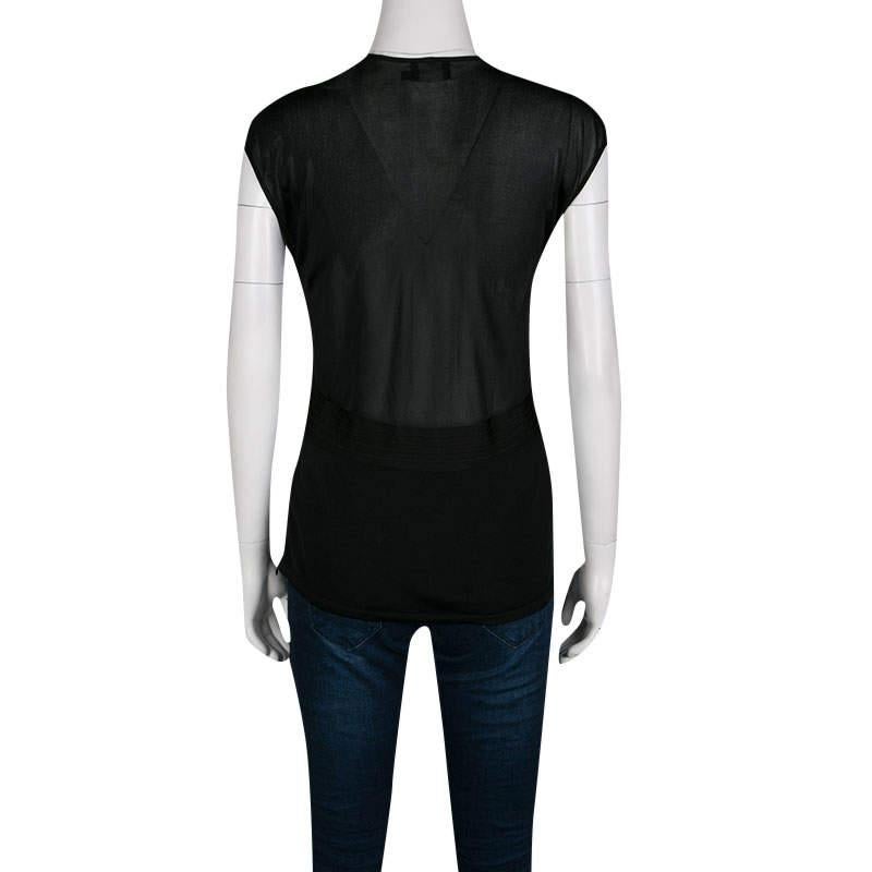 Be party ready in this beautiful top from Giorgio Armani. Designed in a classy black shade from 100% viscose, the creation features a deep V-neckline with a twisted knit detail on the front. The sheer top can be worn with high waist skirts and pants