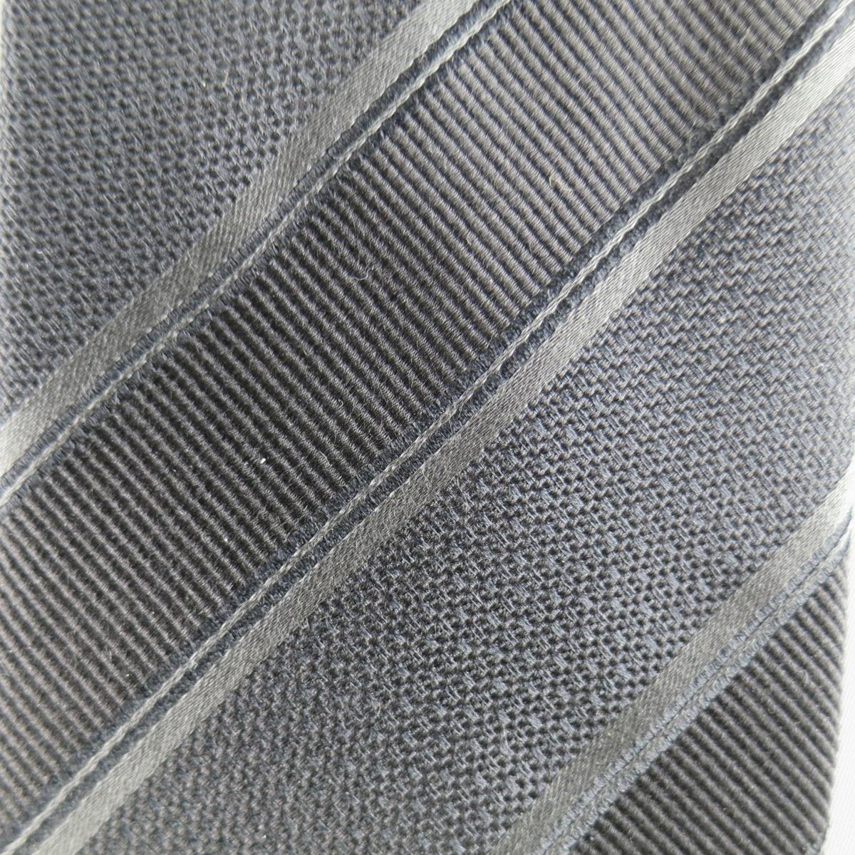 GIORGIO ARMANI Tie consists of 100% silk material in a black color tone. Designed in a classic style, stripe and textured pattern. Handmade in Italy.
 
Fair Pre-Owned Condition
Measurements
 
Width: 9.5 cm.
Length: 155 cm.