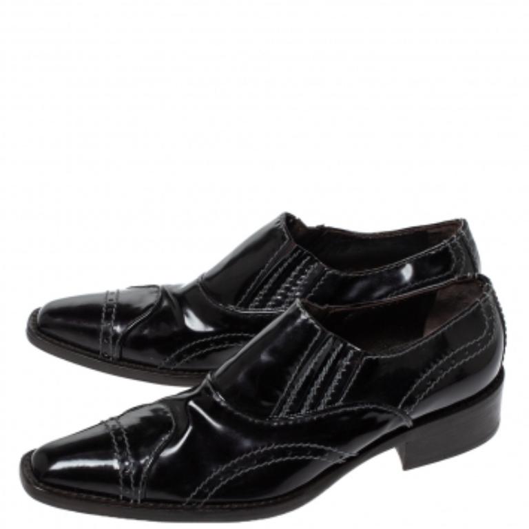 These loafers by Giorgio Armani deliver glamour and comfort. Crafted from glossy patent leather, they come in a classic shade of black. They are styled with tapered toes, stitch detailing, 3.5 cm heels, leather soles and insoles.