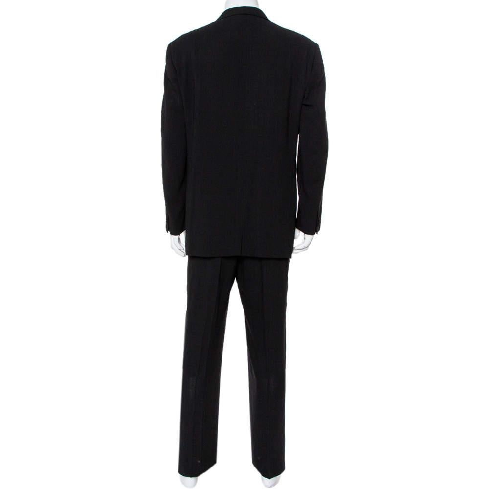This black suit from Giorgio Armani is a classic creation meant to elevate your formal look. Made from quality wool, the blazer features contrast lapels, a single button front closure, and the trousers feature contrast trims on the sides and a