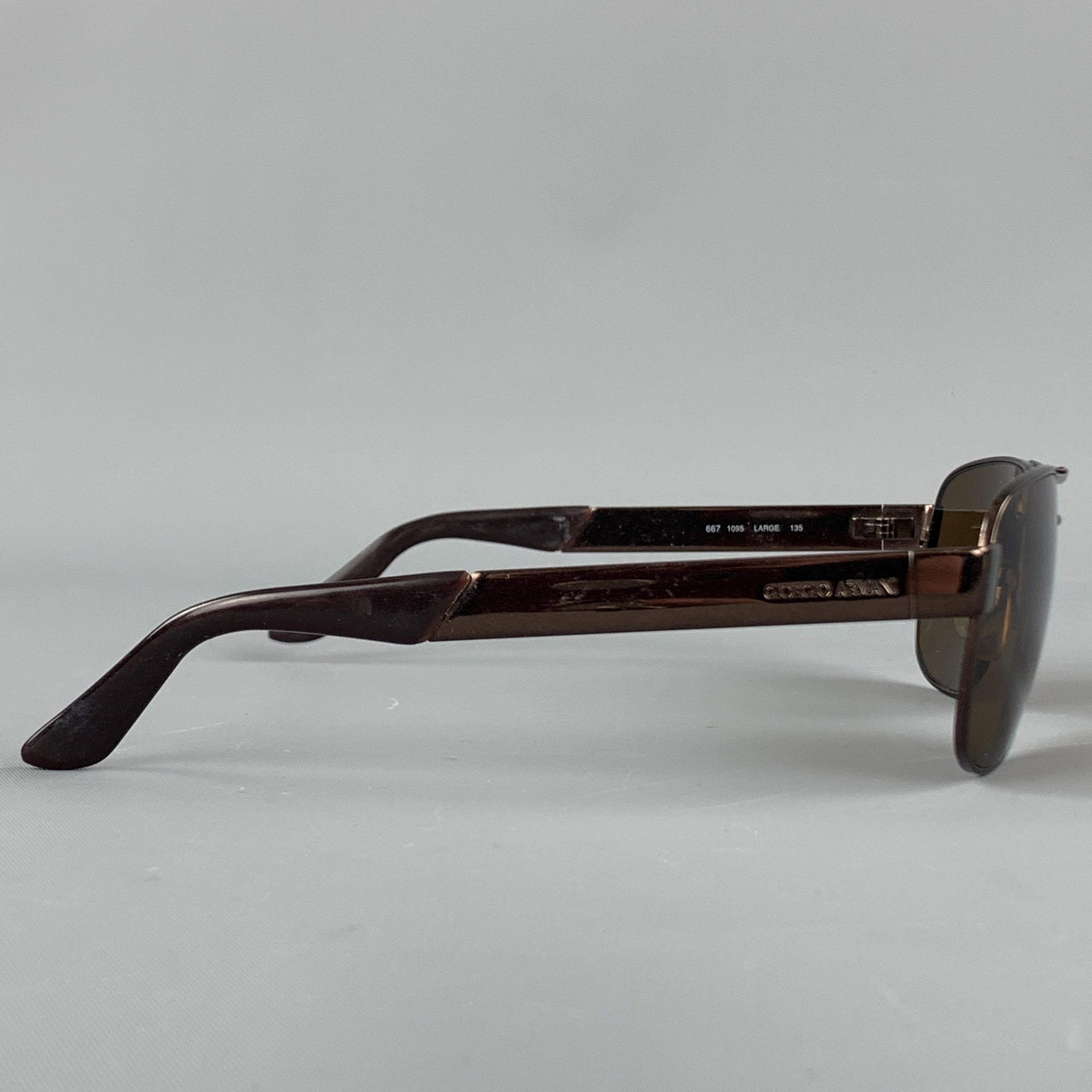 GIORGIO ARMANI sunglasses come in a deep bronze tone metal with square aviator shaped lenses. Made in Italy.

Excellent Pre-Owned Condition.
Marked: LARGE 135

Measurements:

Length: 14 cm.
Height: 4.5 cm.