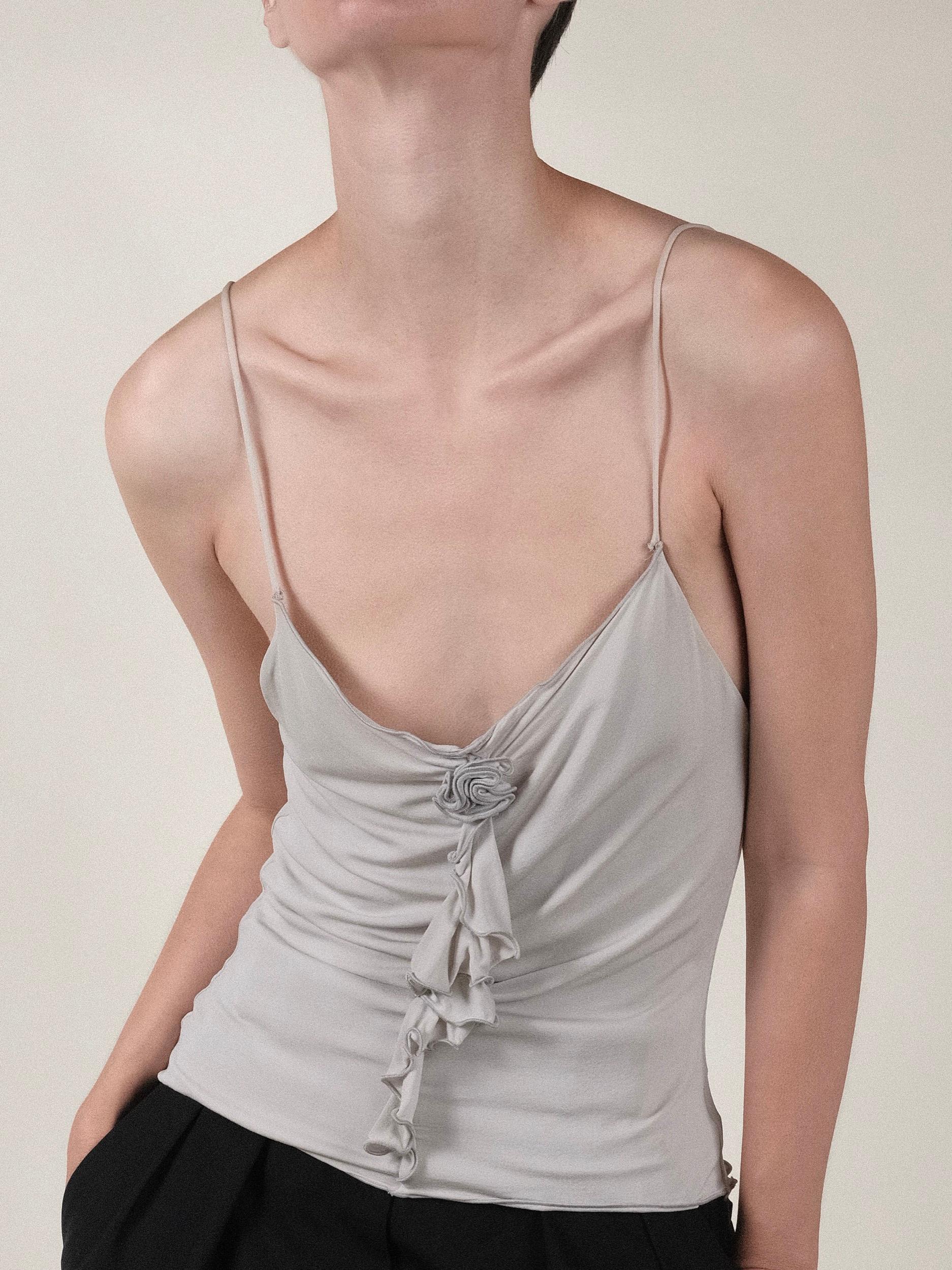 Vintage 1990's Girgio Amani Camisole Tank Top with ruffle and rose detailing
Light, icy, grey
Double layered with bonded seam
Seam detailing down back
Skinny spaghetti strap
Heavy lux viscose
Rolled and expertly finished strap

Flat