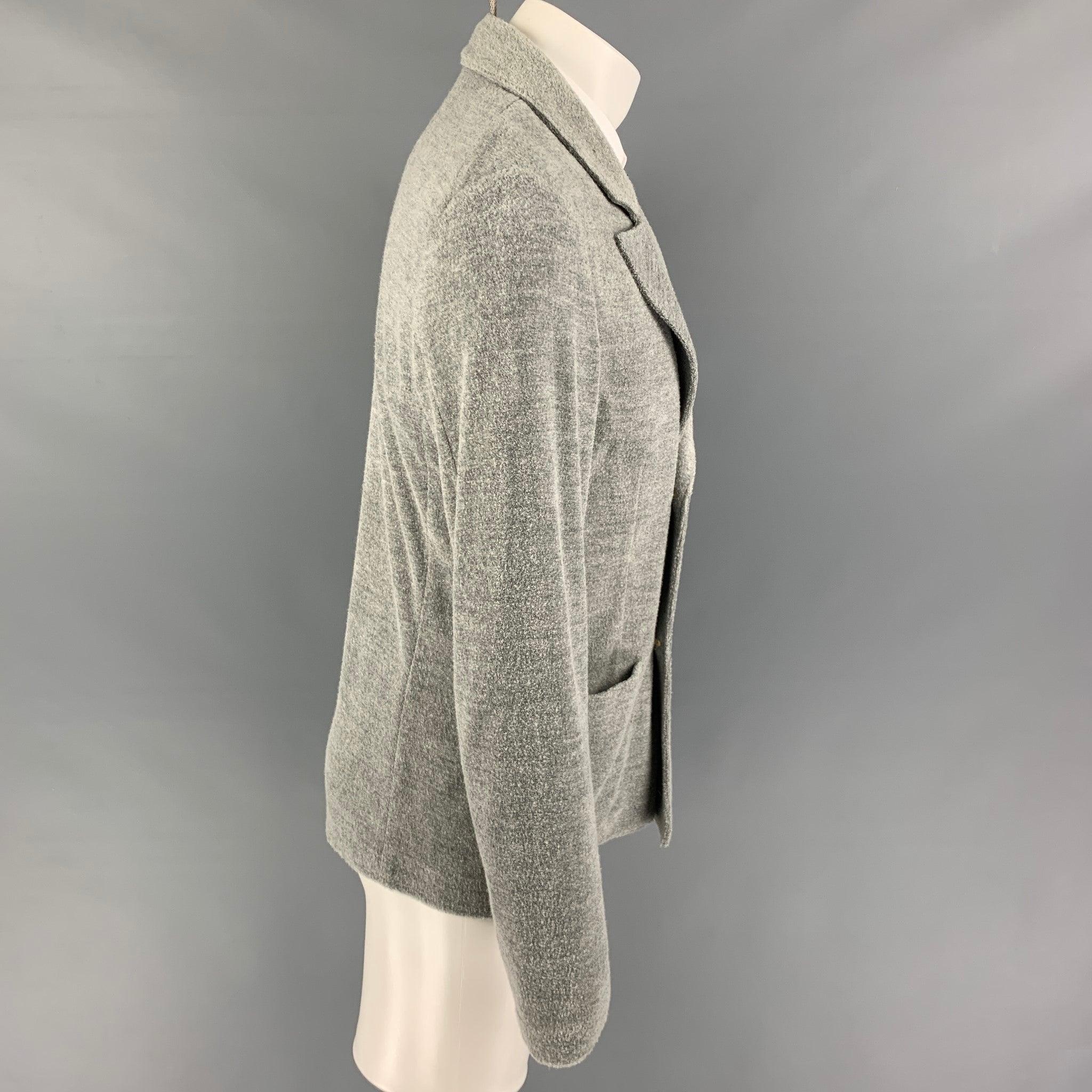 GIORGIO ARMANI sport coat comes in a gray textured cotton blend featuring a peak lapel, patch pockets, and a double breasted closure. Made in Italy. Very Good
Pre-Owned Condition. 

Marked:   52 

Measurements: 
 
Shoulder: 18 inches Chest: 42