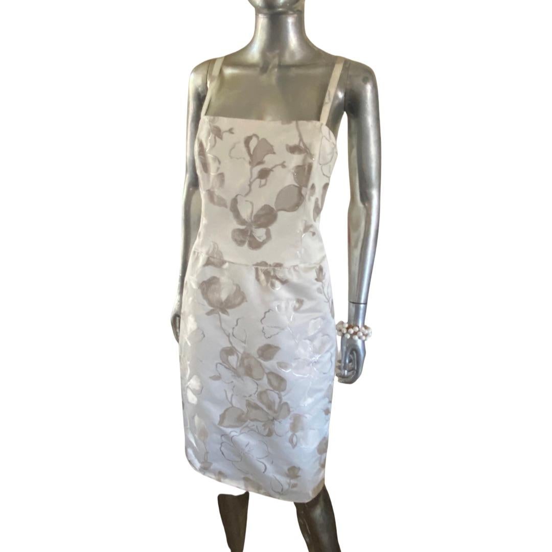 This dress design by Giorgio Armani for Collezioni label is made in Italy. It’s very reminiscent of a 1960s Italian cocktail sheath dress. Fabric is a beautiful silver metallic floral jacquard fabric. Lined in sateen. US size: 12. Italian size: 48.