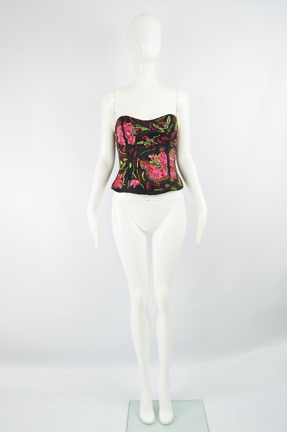 A fabulous women's bustier by Armani Collezioni in a black satin with a fine mesh over the top that is heavily embellished with pink sequins, red fuzzy embroidery and green floral beading. Perfect for a party. 

Size: Marked US 6 / IT 42 which