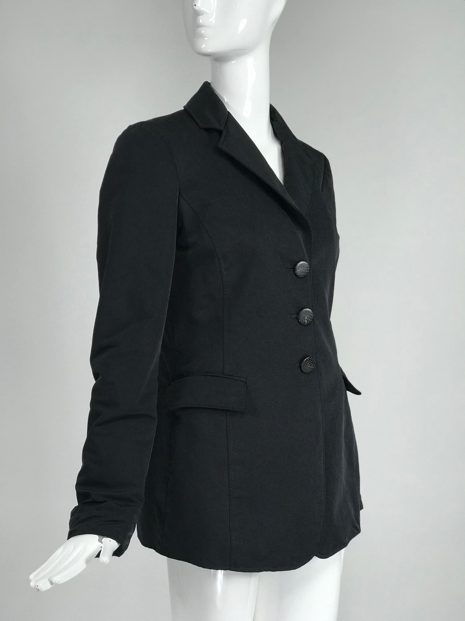 Giorgio Armani Collezioni black nylon single breasted riding style jacket. Single breasted jacket with princess seams, button front, notched lapels, insulated for warmth, 
decorative flap pockets. The jacket has a yoke shoulder back and hem center