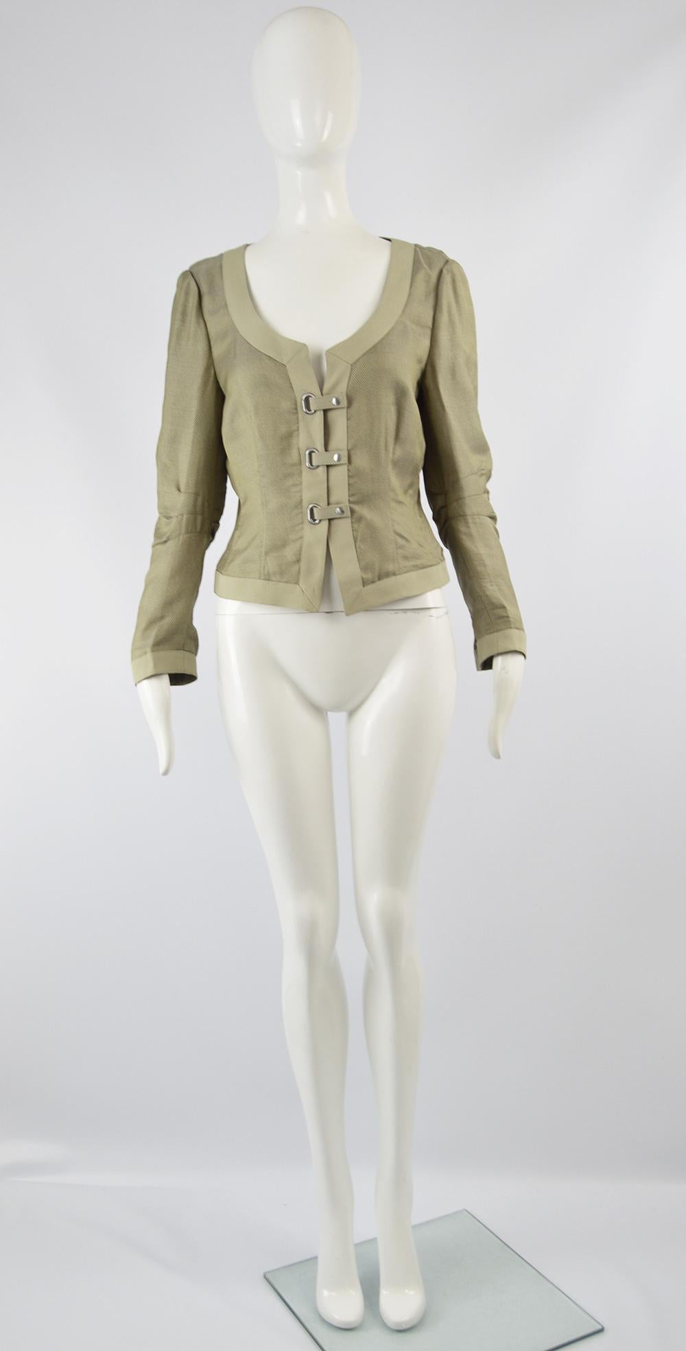An excellent women's jacket by luxury Italian fashion designer Giorgio Armani. In a lightweight silk and rayon mesh / organza slightly iridescent fabric with a grosgrain trim and unique snap loop fastening that gives a futuristic, avant garde feel.
