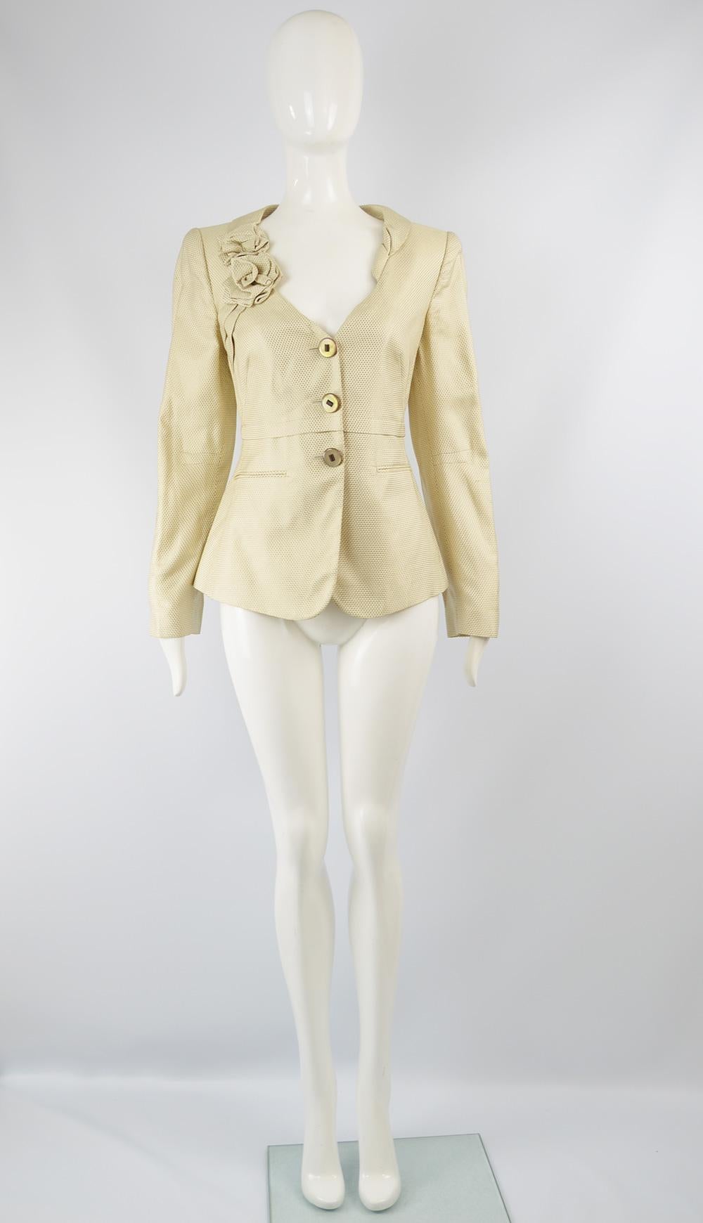 A stunning vintage women's jacket by Giorgio Armani. Made in Italy, in a cream textured rayon and silk brocade / jacquard with folded flowers detailing the asymmetrical lapels. It is beautifully tailored wih a fitted waist and darts shaping the