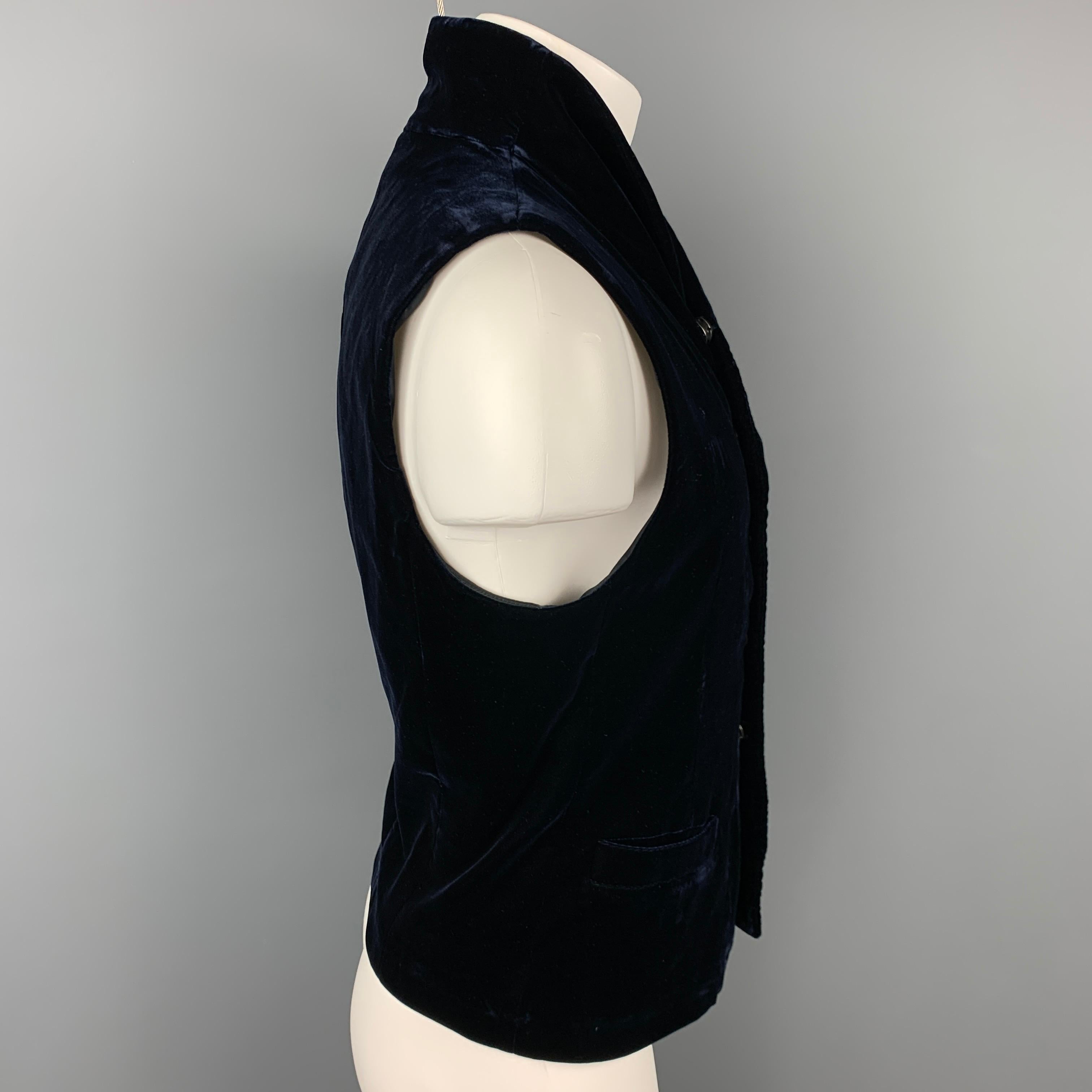 GIORGIO ARMANI vest comes in a dark blue velvet with a full liner featuring a waistcoat style, shawl collar, slit pockets, and a snap button closure. Made in Italy.

Very Good Pre-Owned Condition.
Marked: IT 48
Original Retail Price: