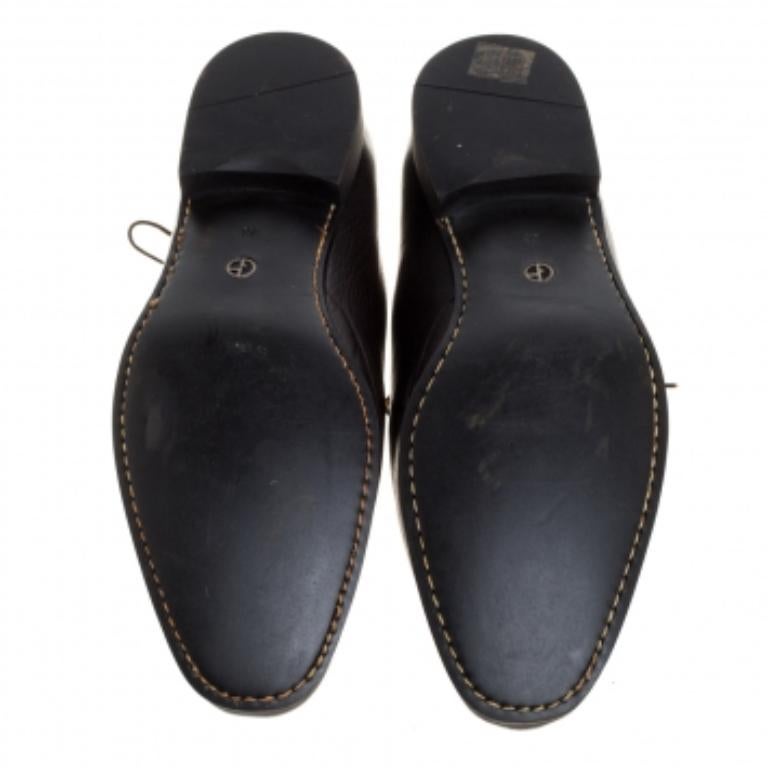 Treat yourself to these dapper Giorgio Armani Oxford shoes. The smooth exterior and the interior are made from dark brown leather. They have low heels, lace-ups uppers, and round toes.