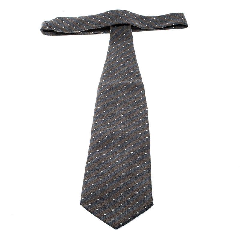 This suave wool and silk tie from Giorgio Armani is perfect for the handsome you. Designed with diagonal stripes and dots in jacquard, this tie comes with the label and a keeper loop on the back. Wear this to your most important meetings and you are